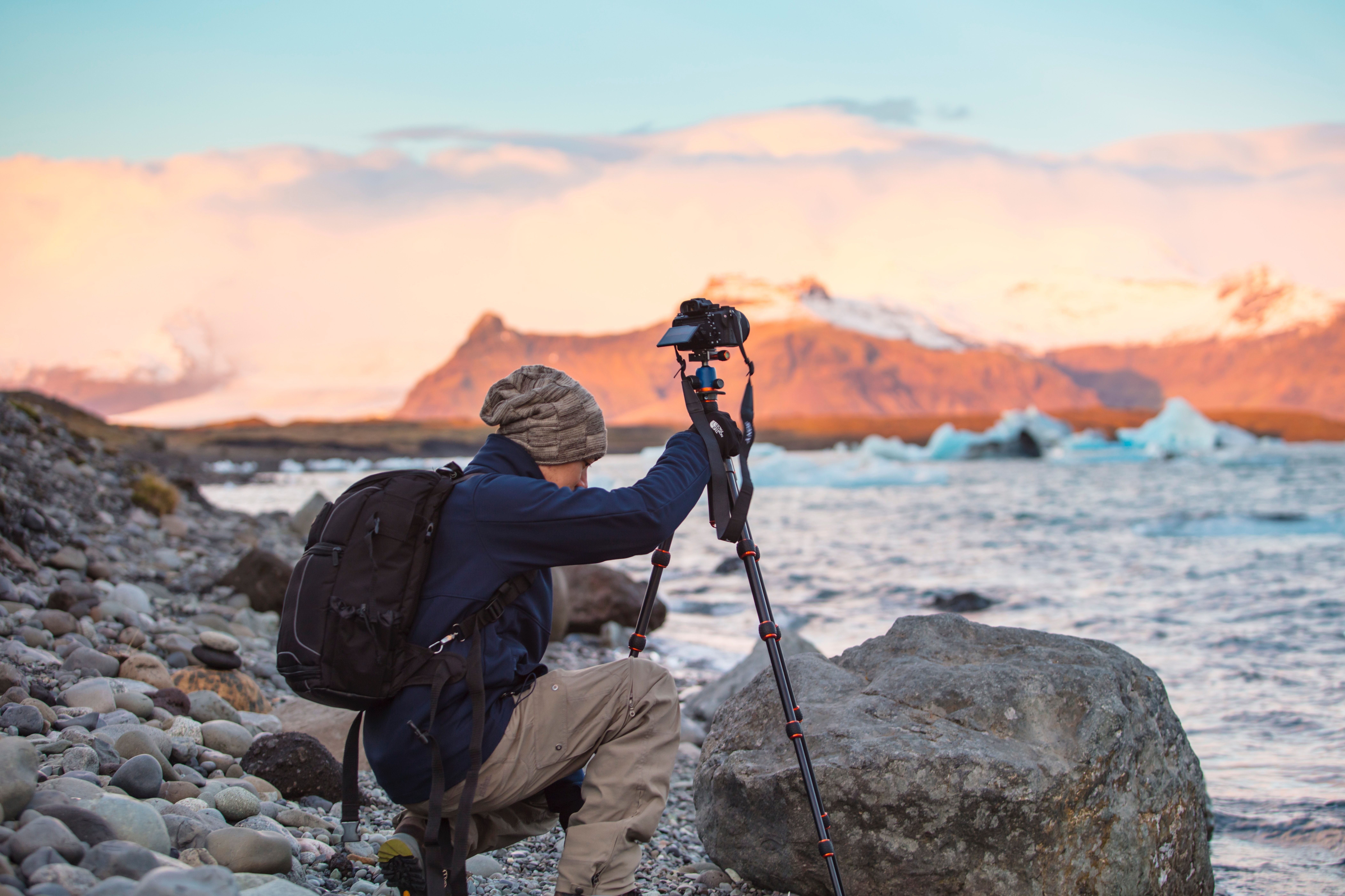 person using camera with tripod in iceland