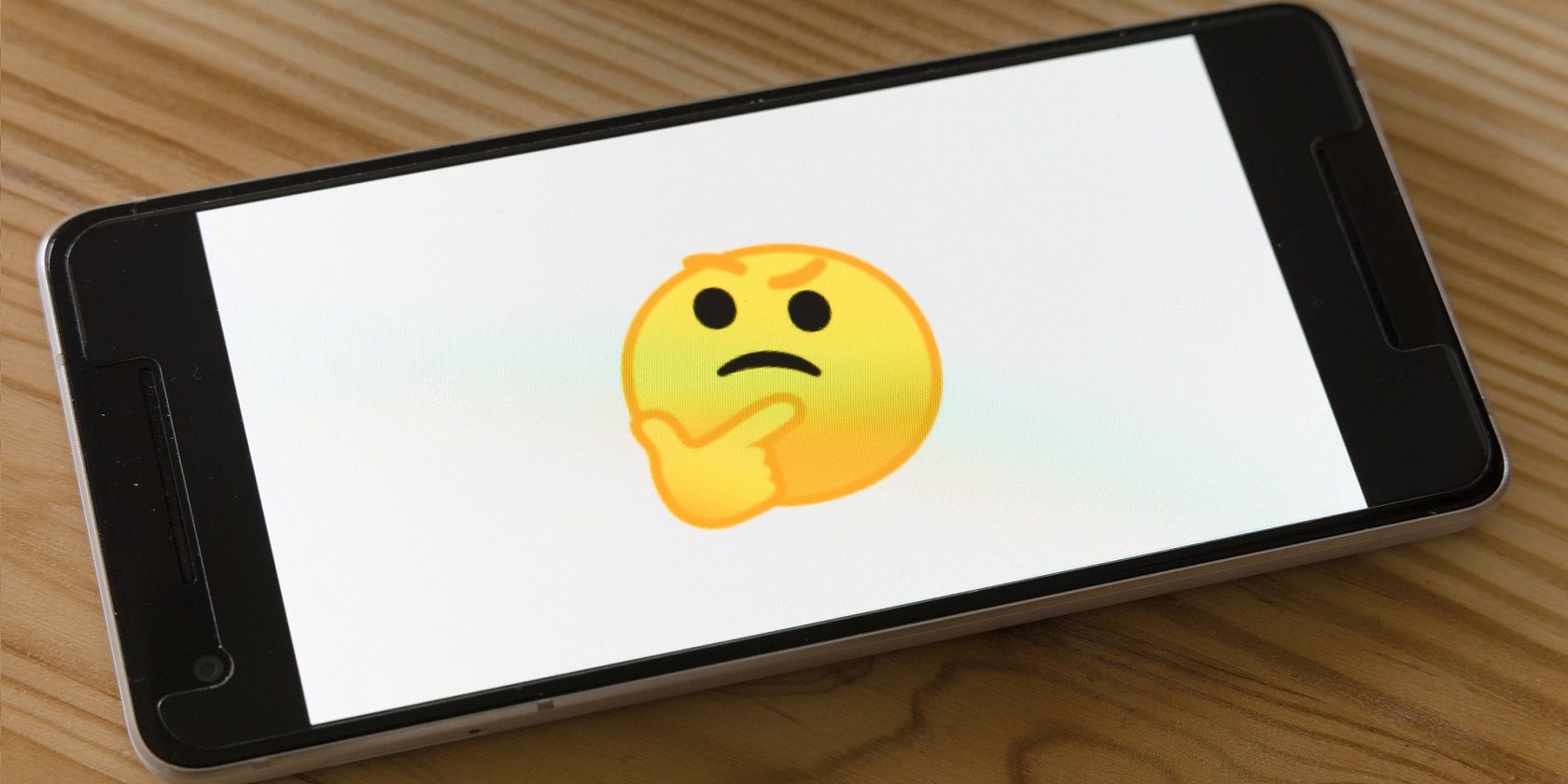 photo of phone with thinking emoji