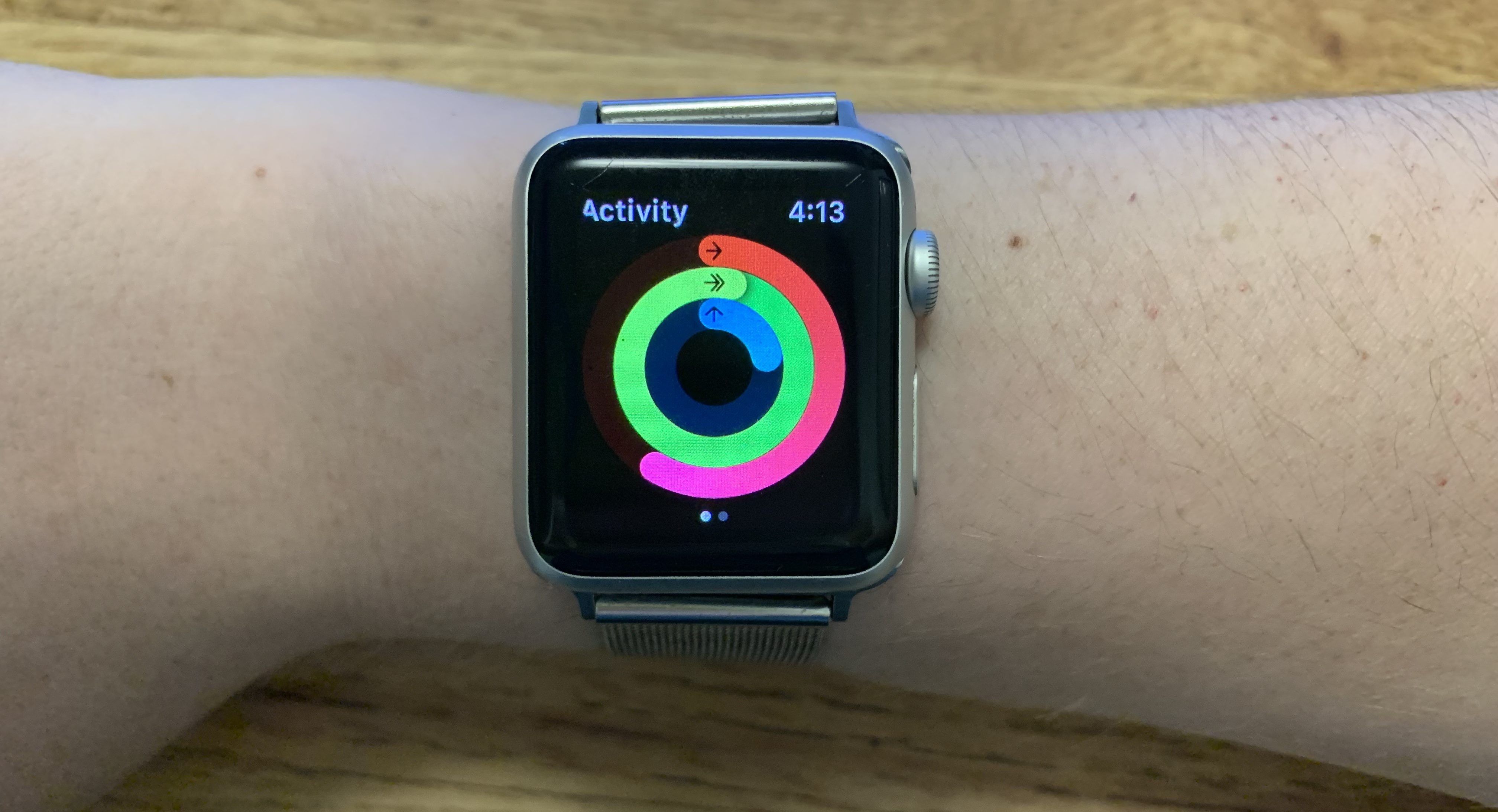 Apple Watch on wrist with Activity app open