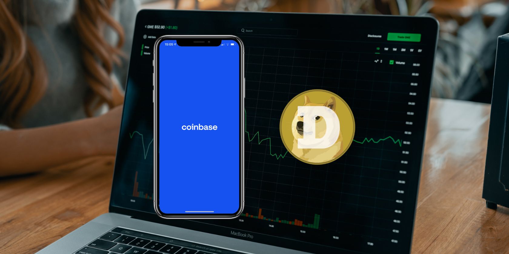 A photo showing Coinbase on an iPhone and the Dogecoin logo in front of a computer trading the crypto in the background.