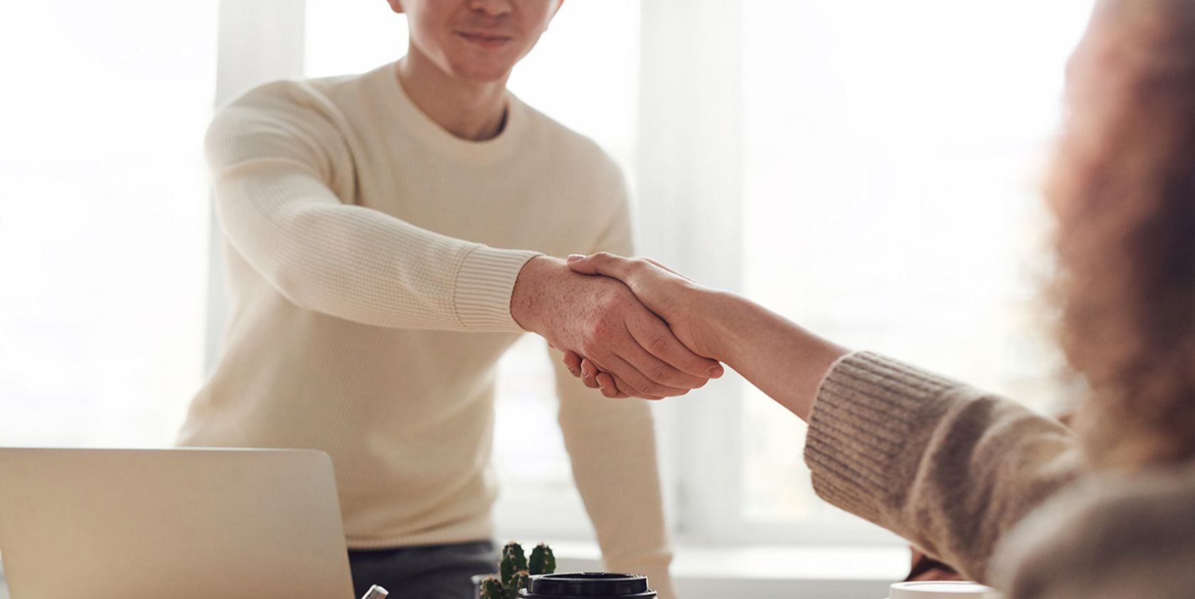people shaking hands in a office setup