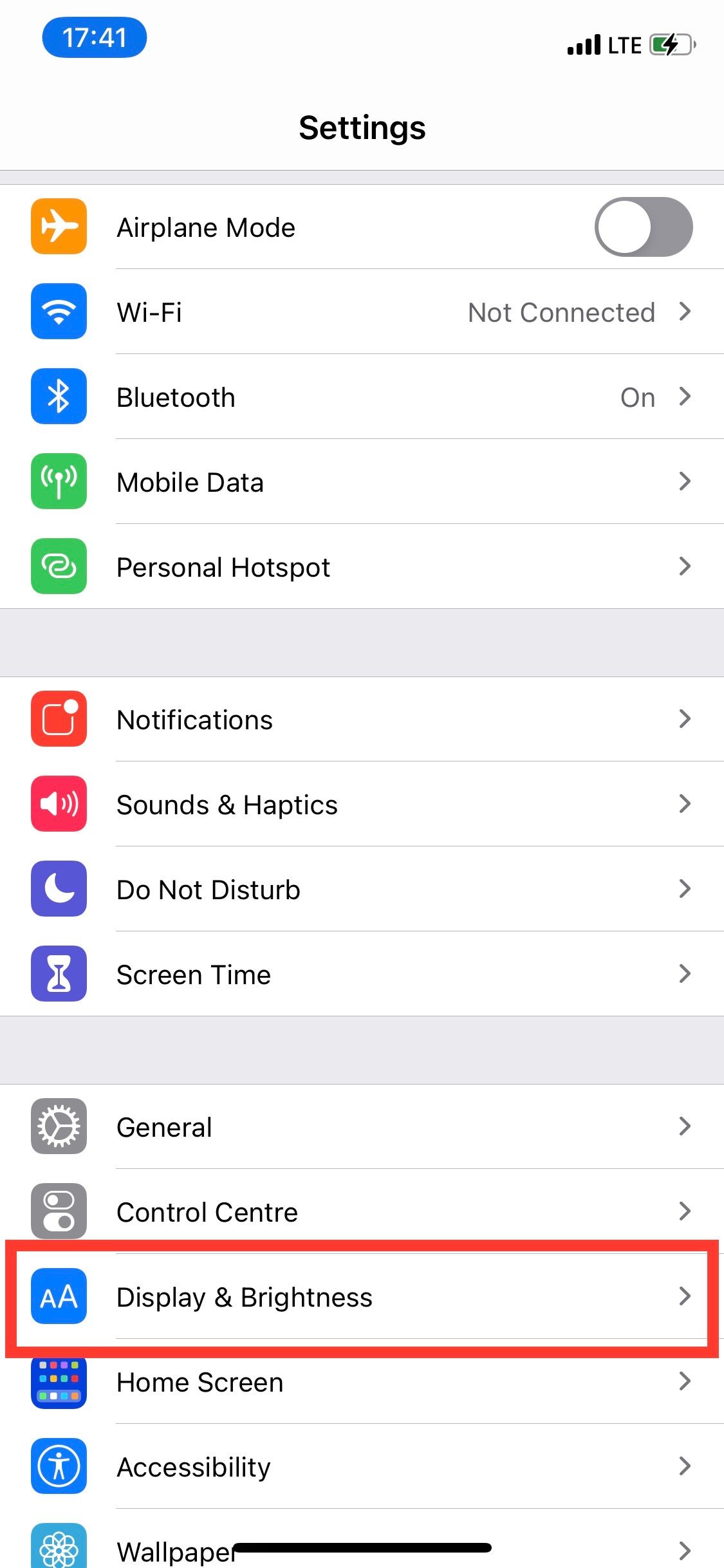 iPhones settings menu with Display & Brightness section highlighted