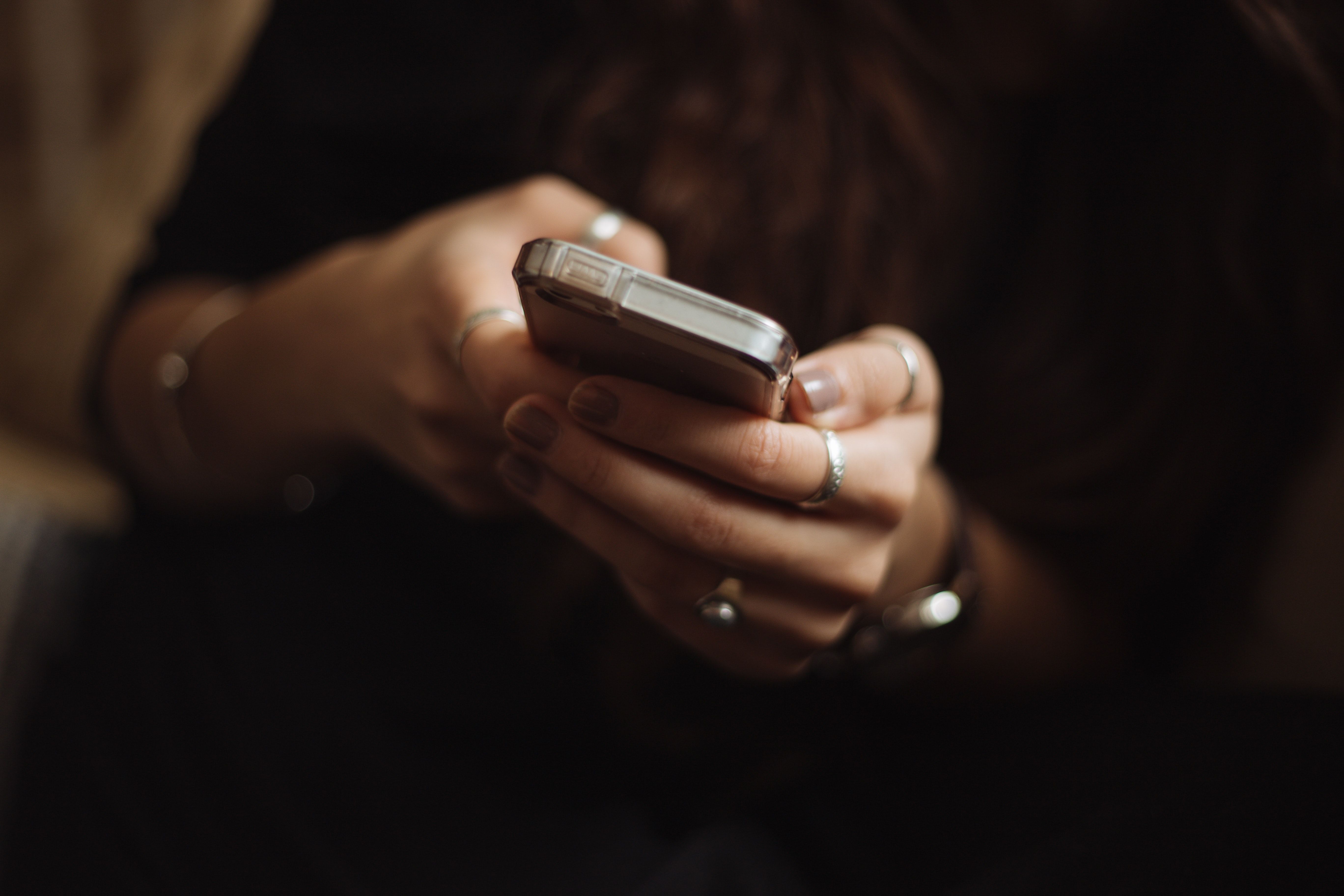 person holding a phone and texting.