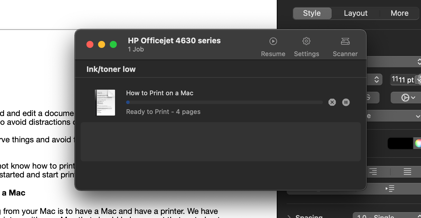 An open, paused printer queue on a MacBook Pro