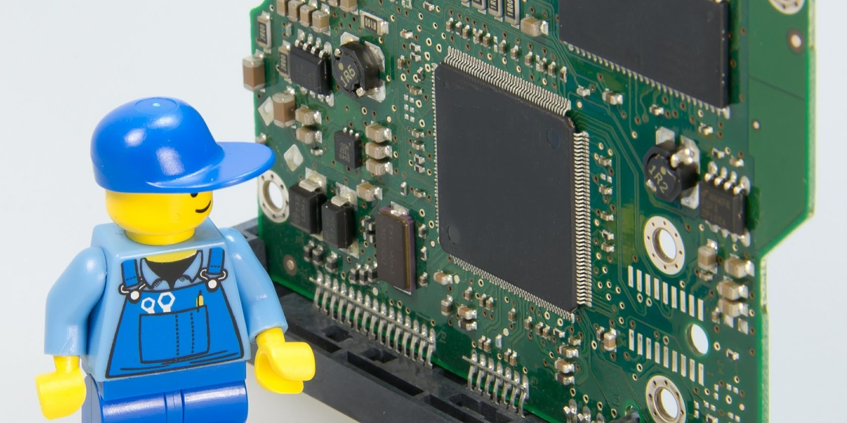 Miner figurine beside a motherboard.