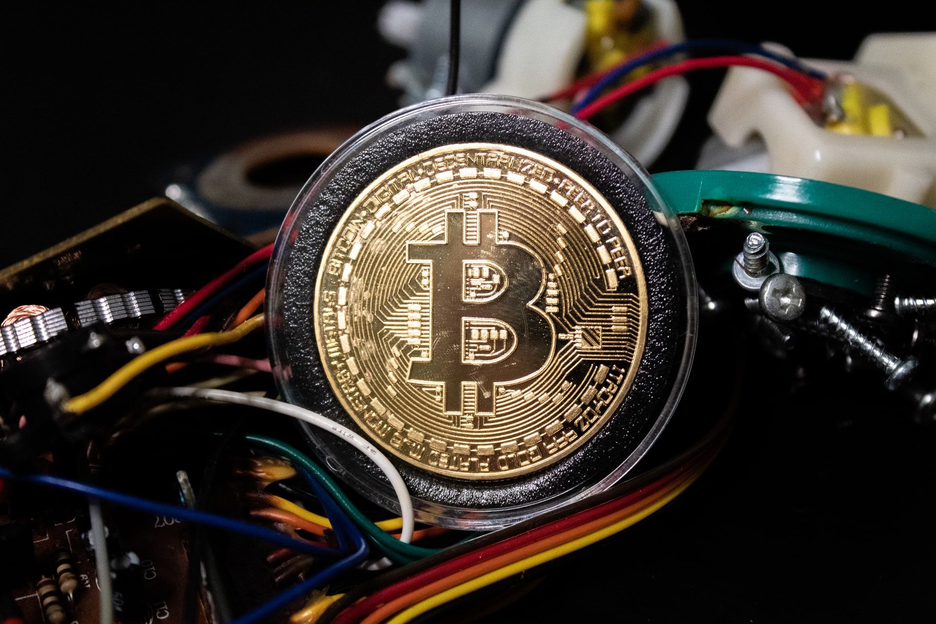 Pexels stock image of a bitcoin leaning against wires on a motherboard