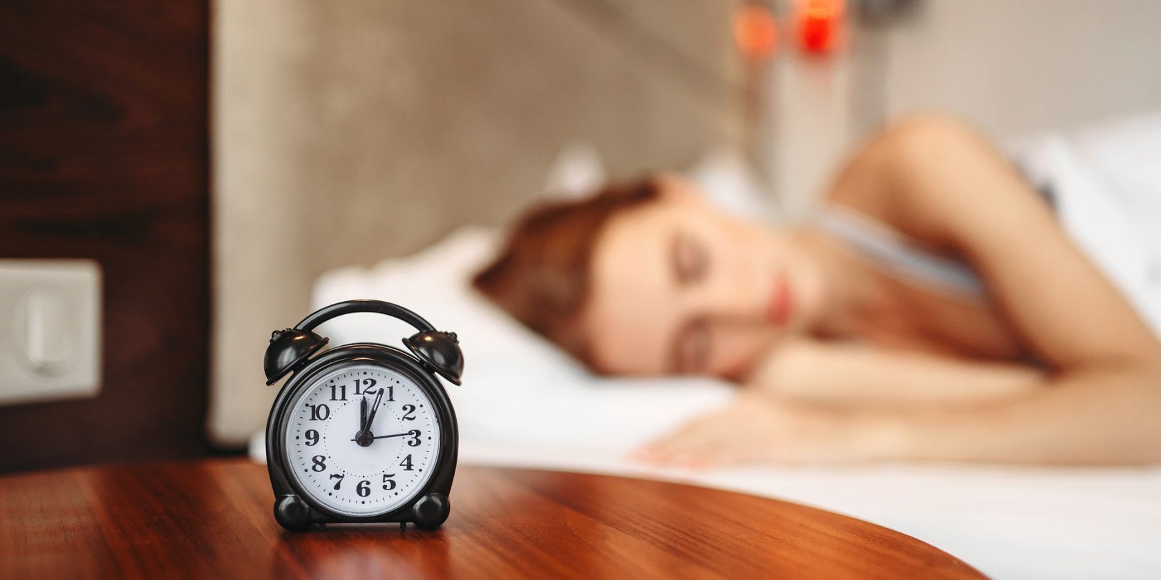 Alarm clock and woman sleeping