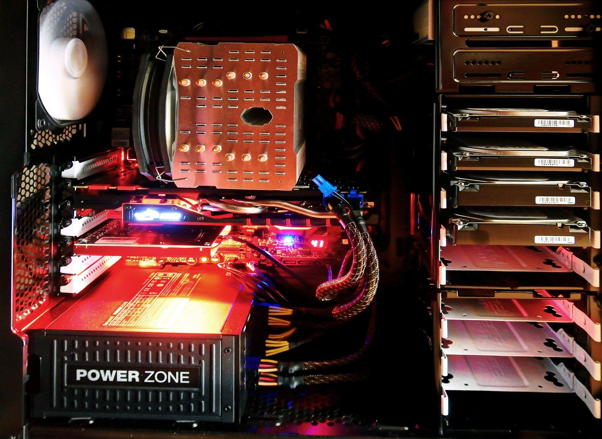 Gaming rig with several HDDs stacked vertically.