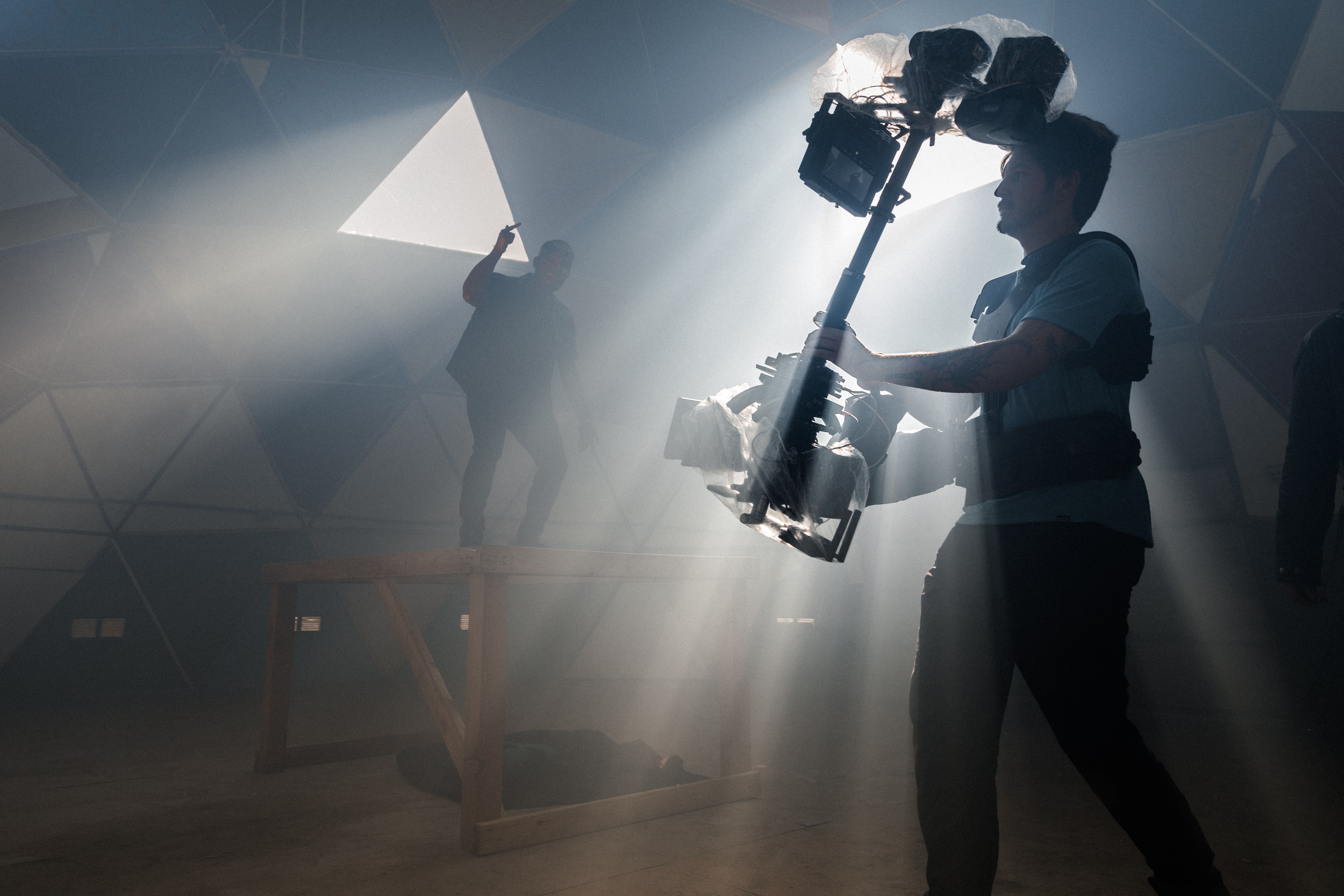 A filmmaker using a Steadicam --- Unspash