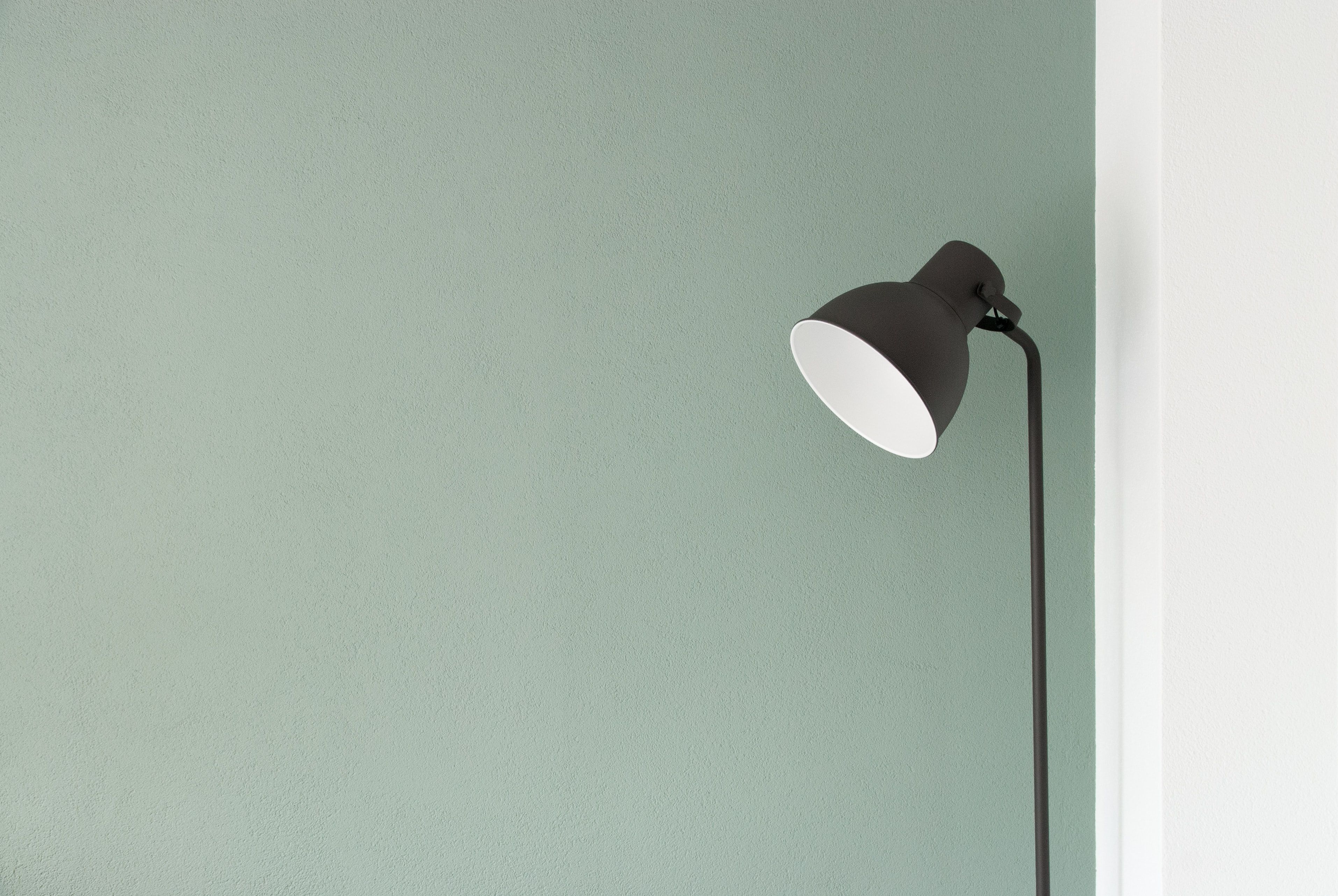 photo of a lamp next to a wall