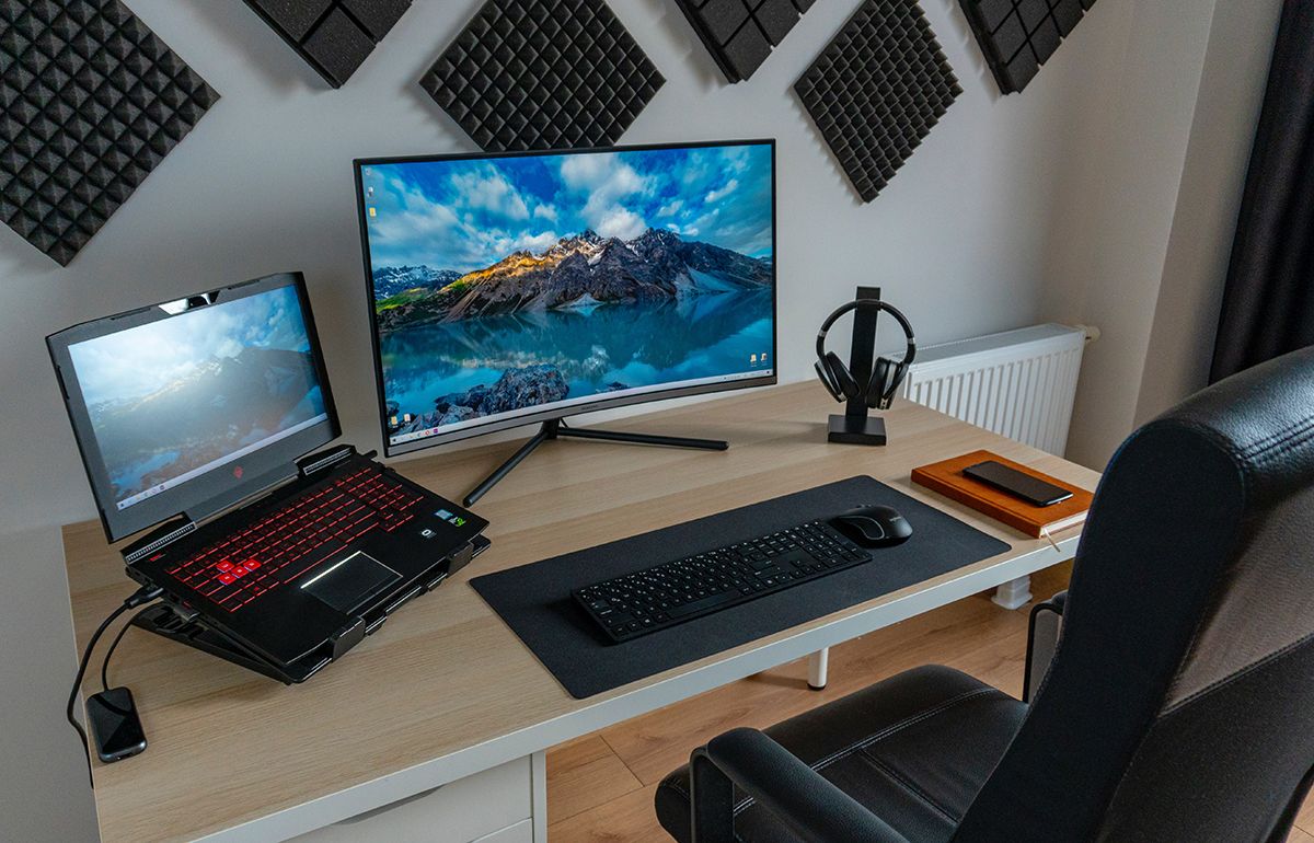 Laptop docked to a monitor on an office desk