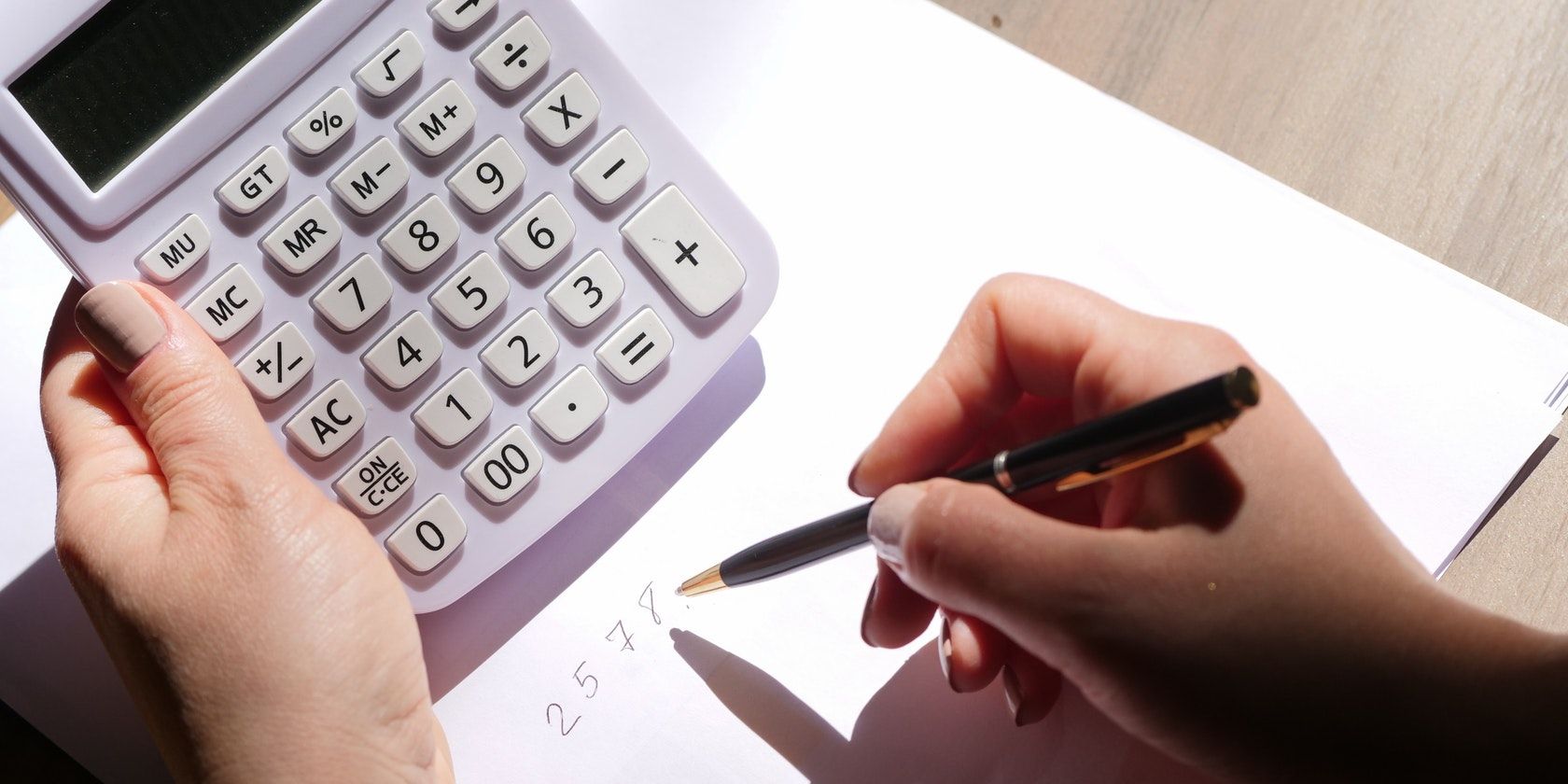 Photo of a man holding a calculator