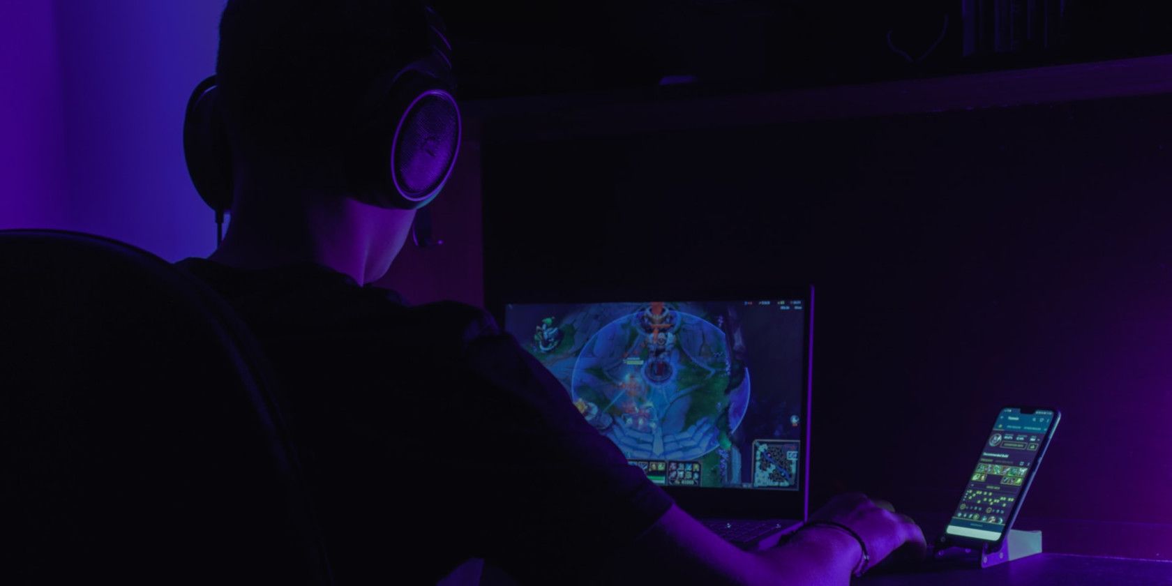 Person Playing a MOBA in a Dark Room