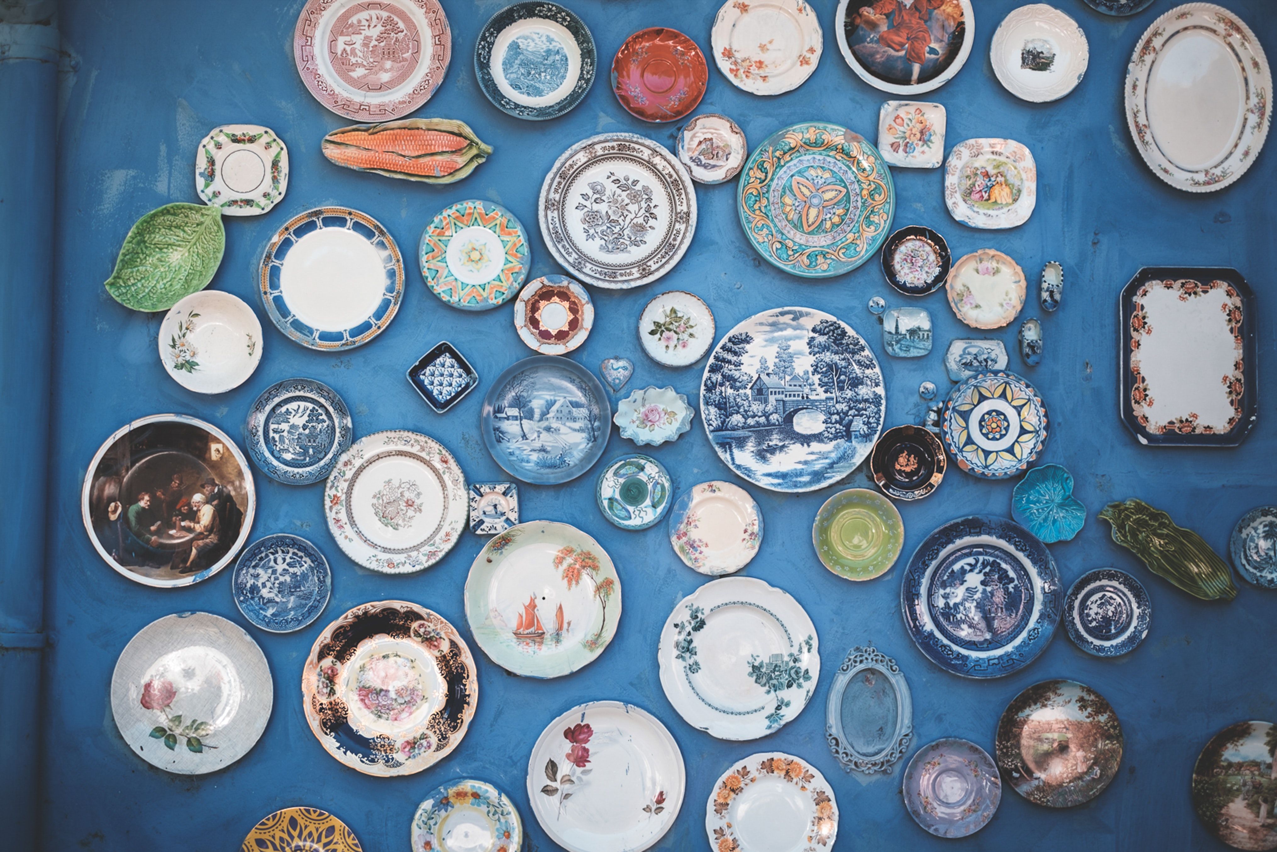 Various antique plates on a blue background