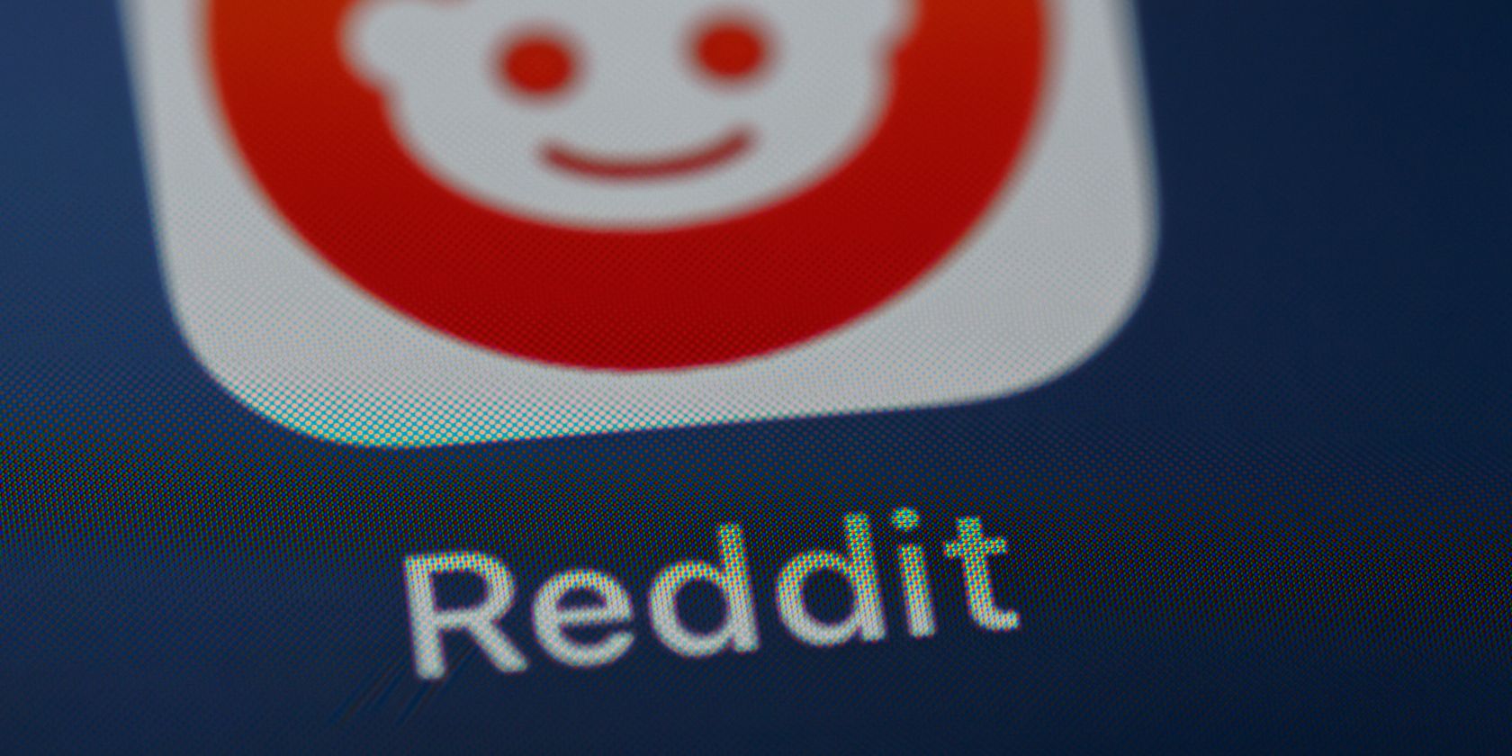 Photo of the Reddit logo on a screen