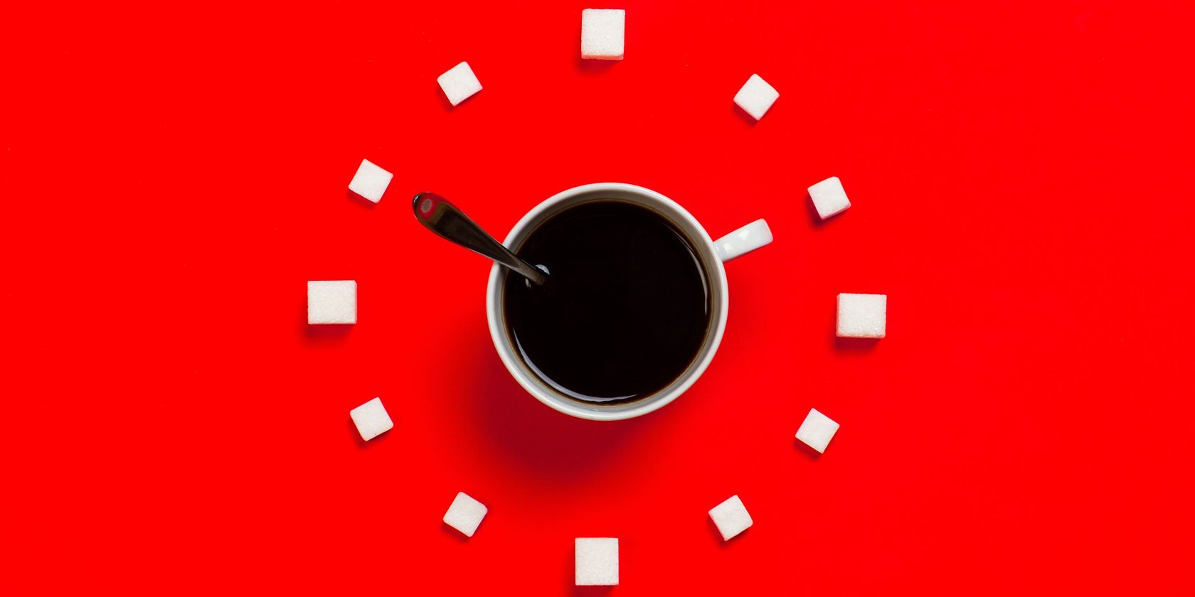 coffee cup and clock on red background