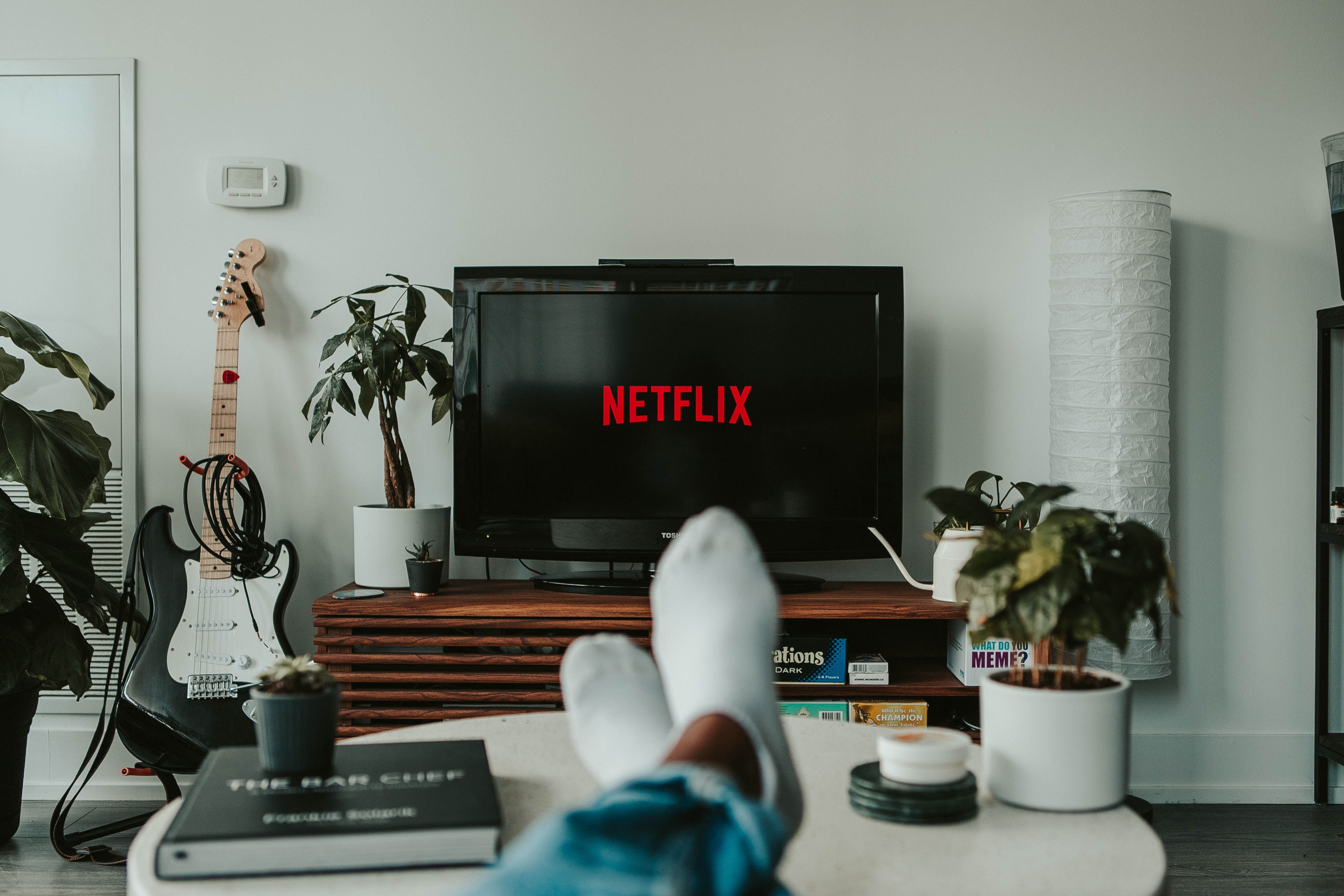 Photo of person with feet up watching TV