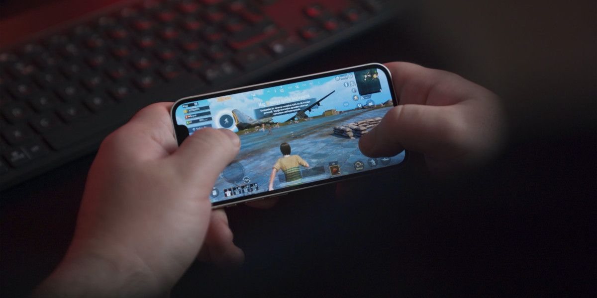 Young Man Playing PUBG on an iPhone