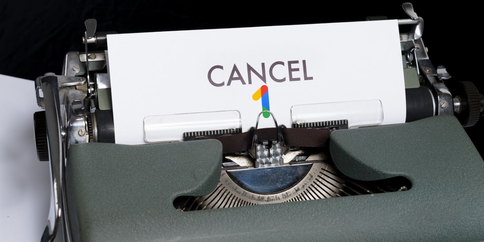 Typewriter with the word Cancel and the Google One logo.