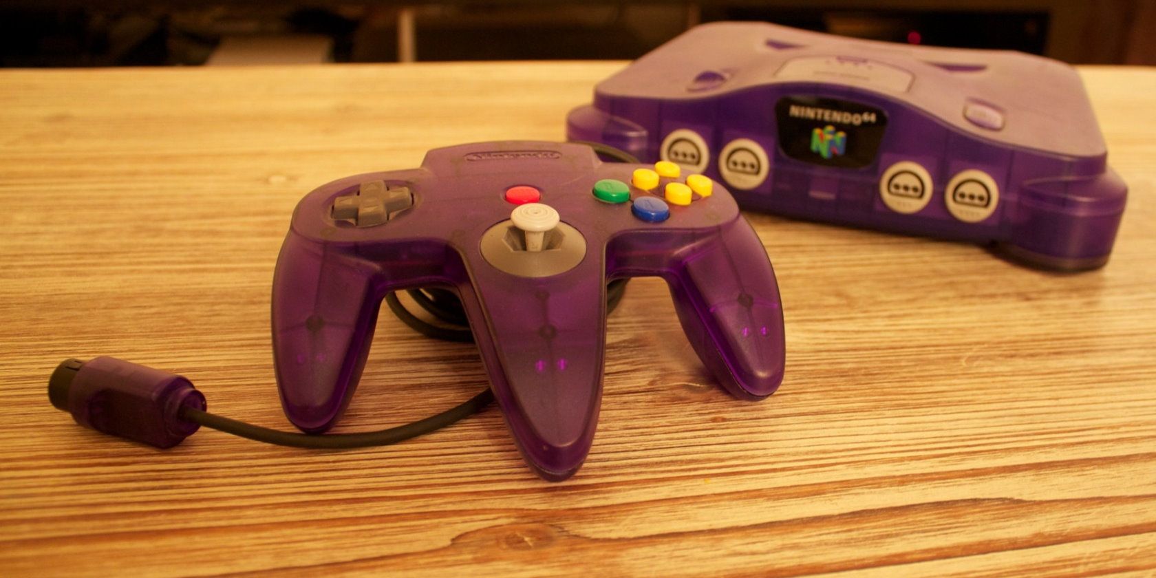 Purple Nintendo 64 console and controller on table