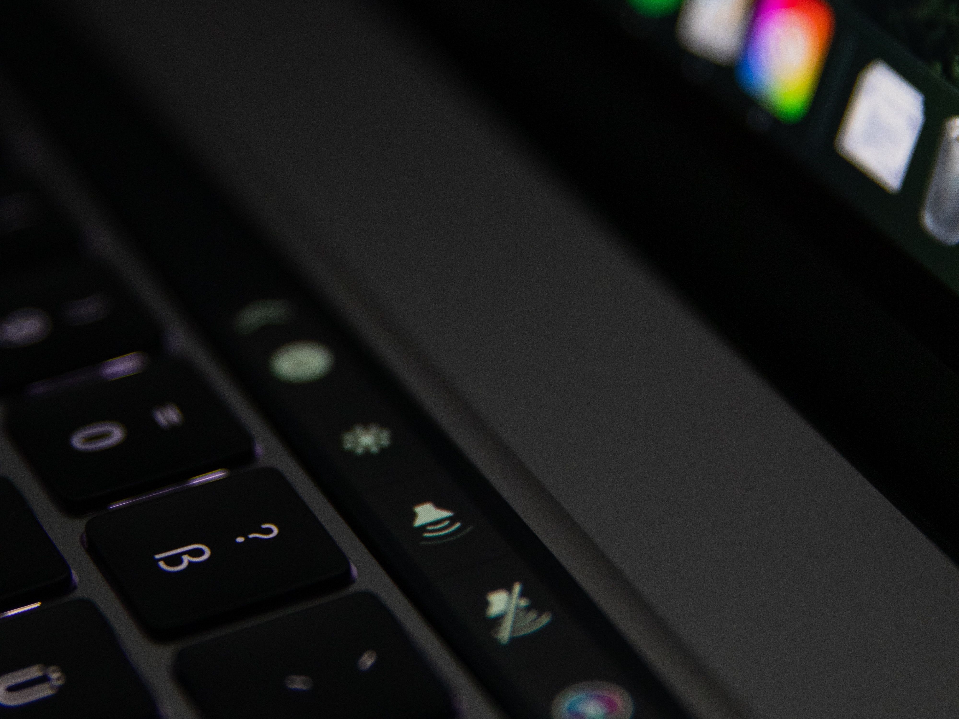 A close up photo of a 4th generation MacBook Pro with Touch Bar