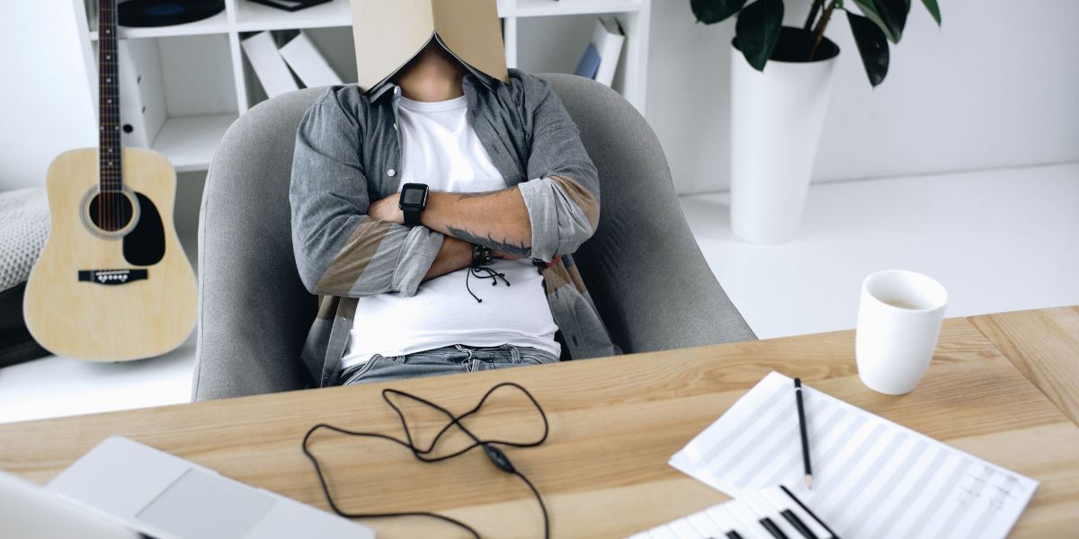 An image showing a person sleeping in a chair while working