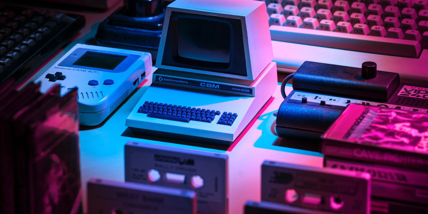 Retro games consoles spread out on table