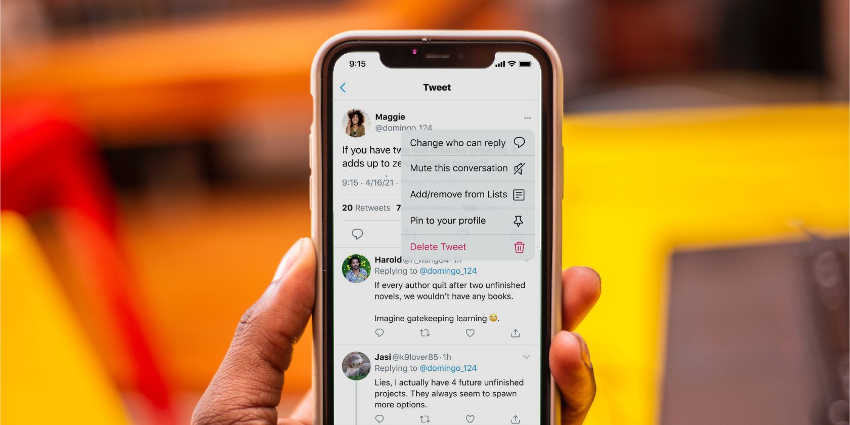 Twitter's new change who can reply feature on an iPhone being held