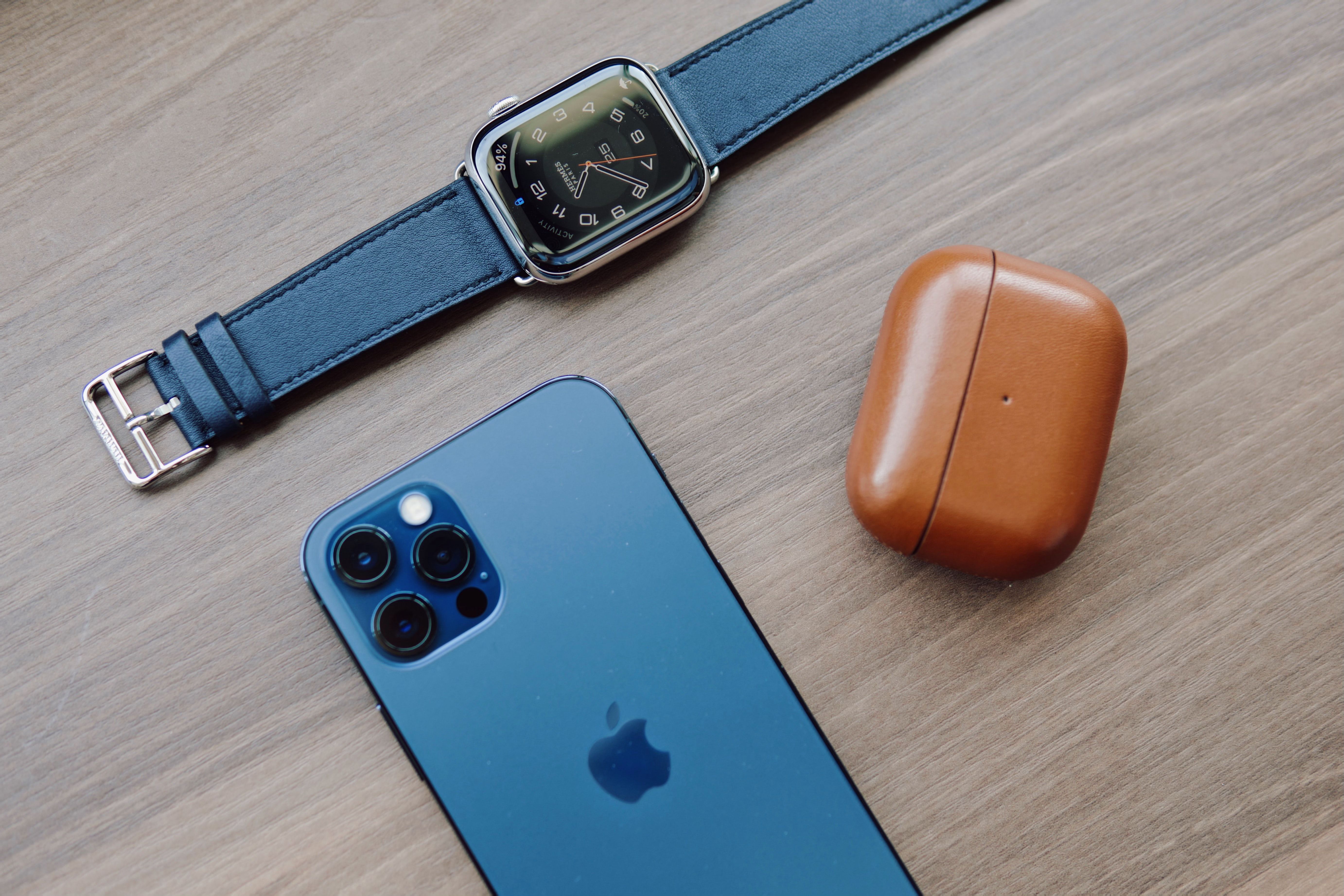Apple Watch, iPhone, and AirPods together on a table.