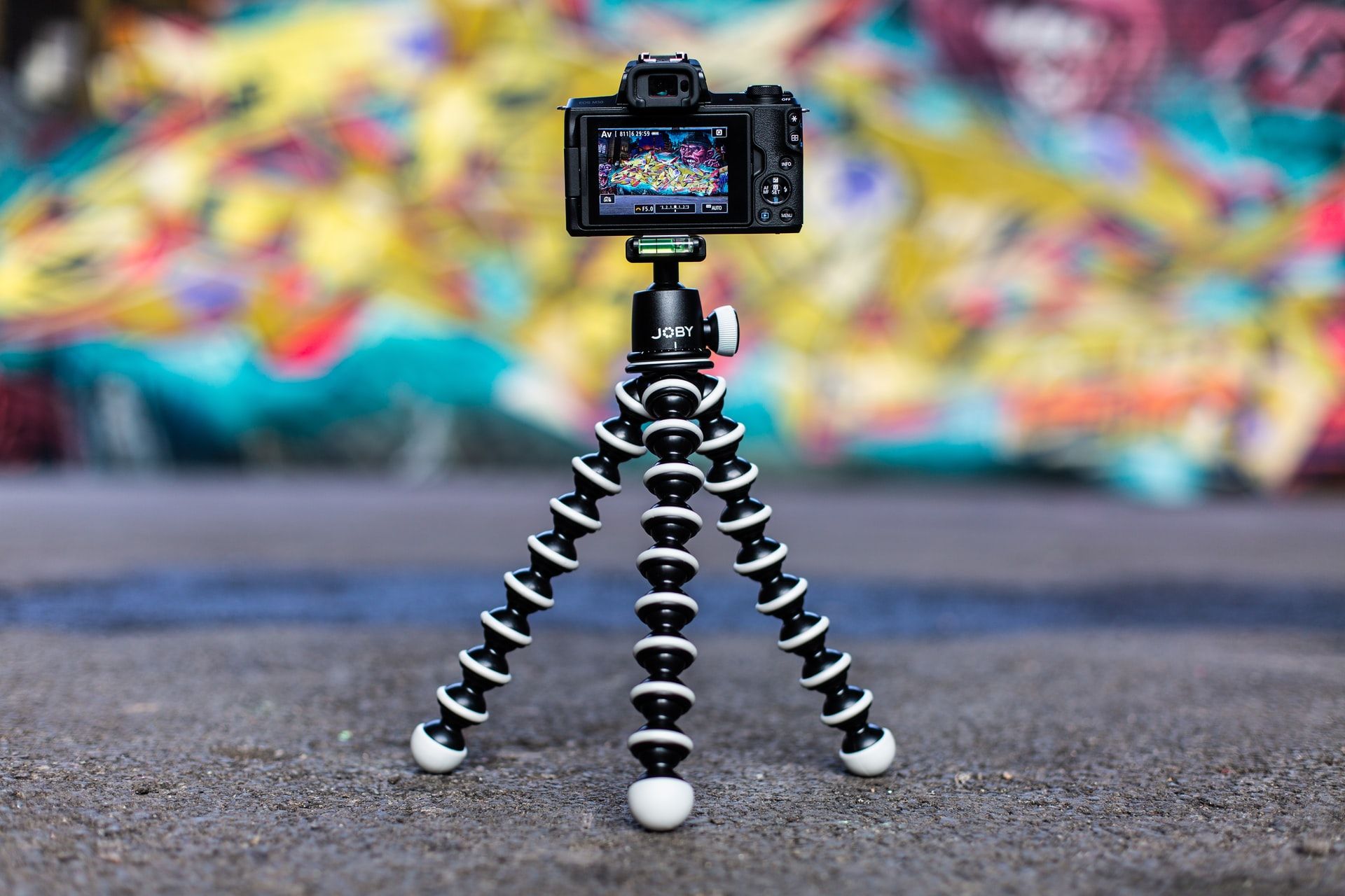 A camera on a tripod taking a photo