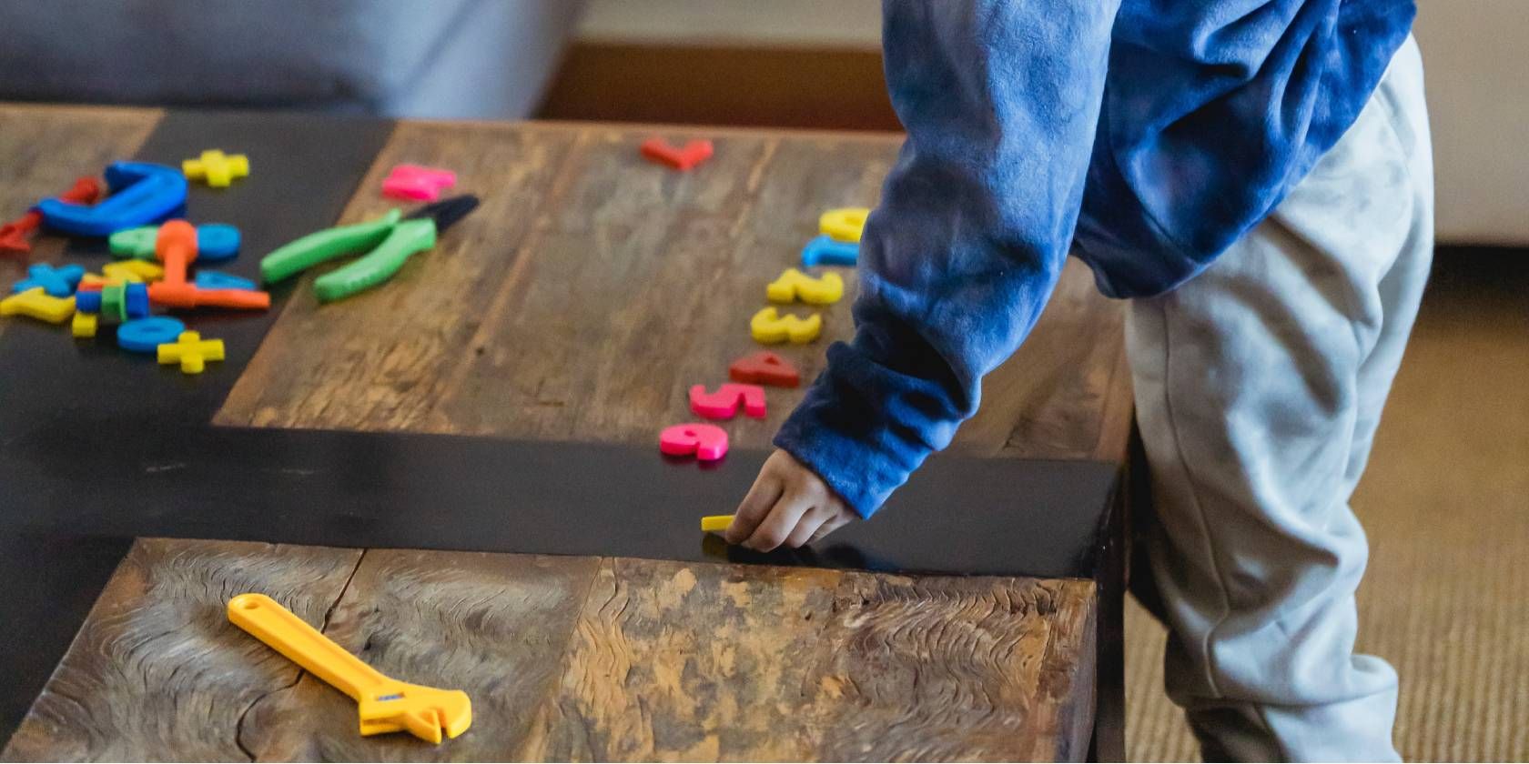 Child Sorting Numbers on a Table