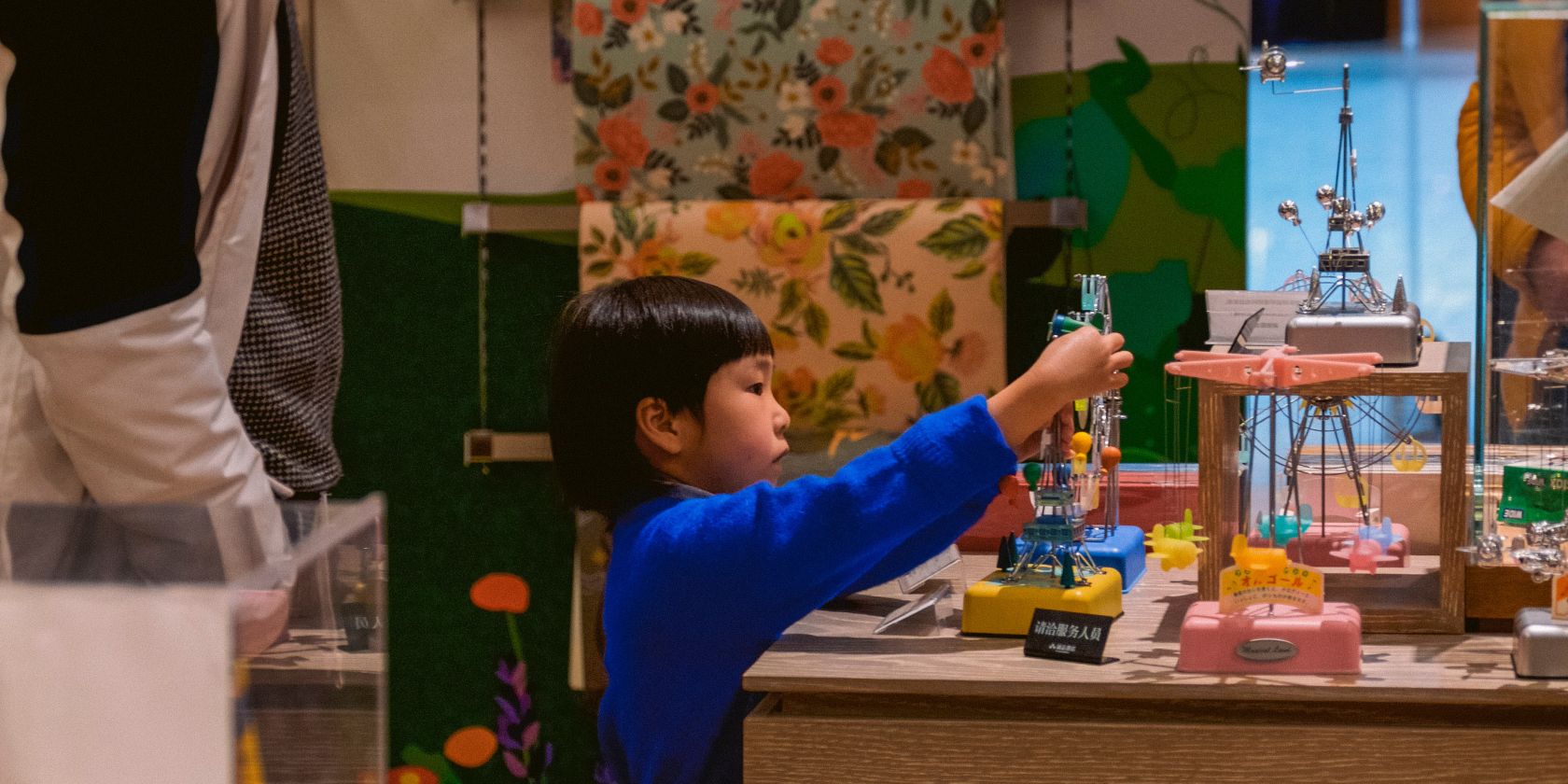 Photo of a child creating something on a table