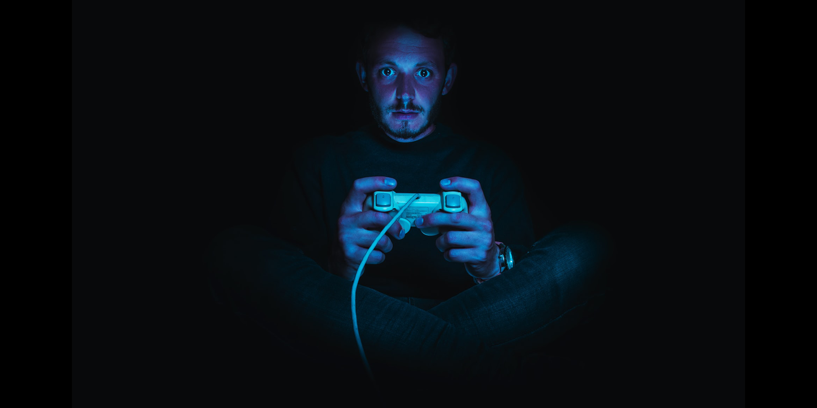 A guy playing video games in the dark