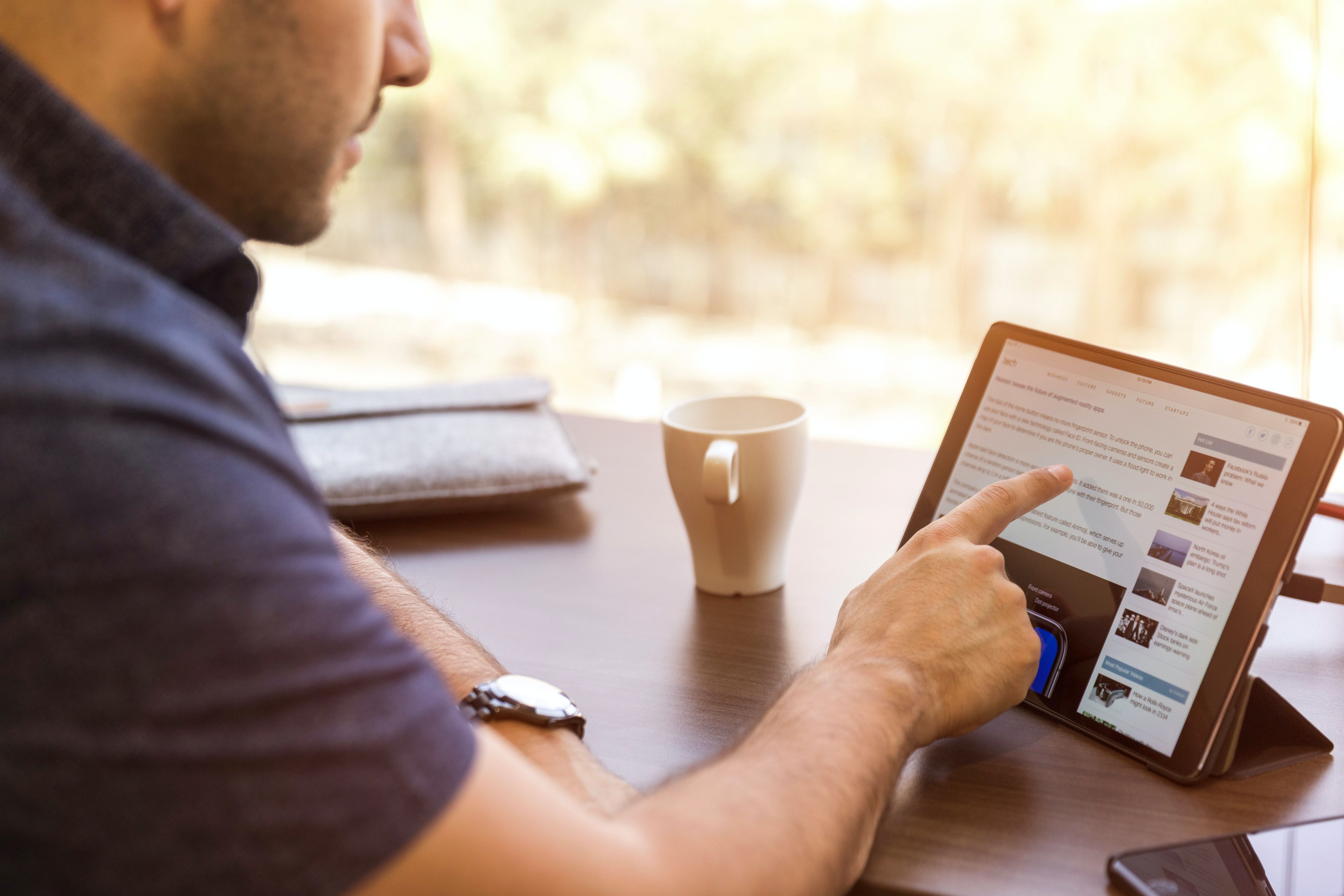 Person browsing LinkedIn on a tablet