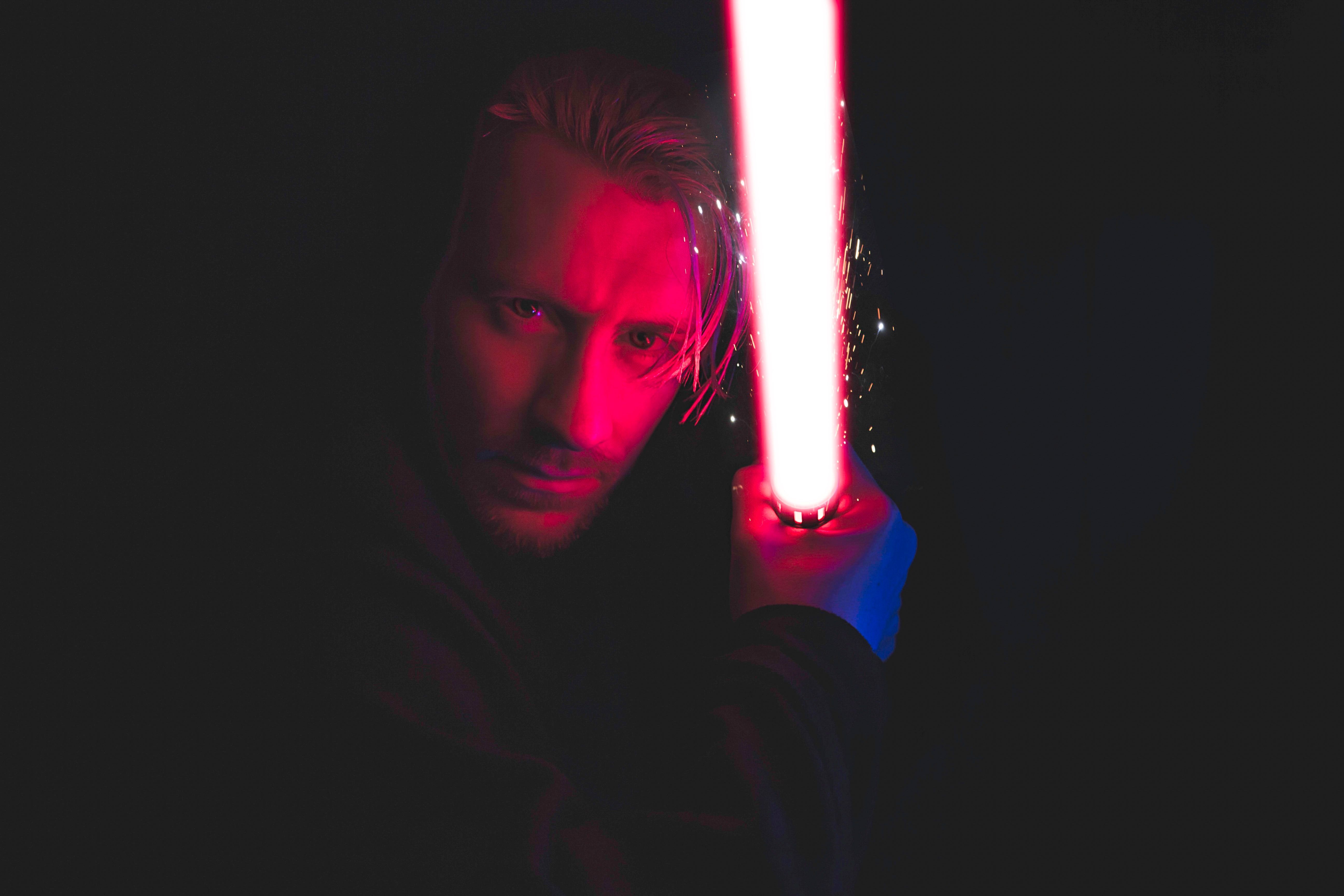 Photo of a person holding something that could resemble a lightsaber