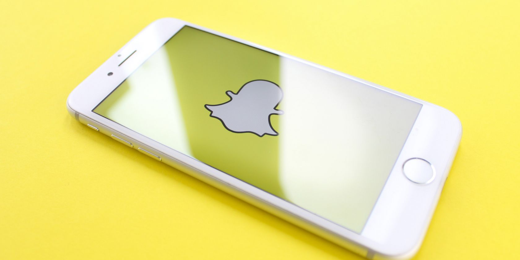 Photo of a phone with the Snapchat logo showing