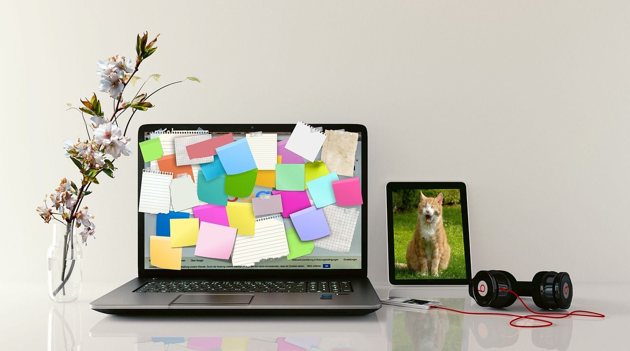 Lots of sticky notes on a laptop screen