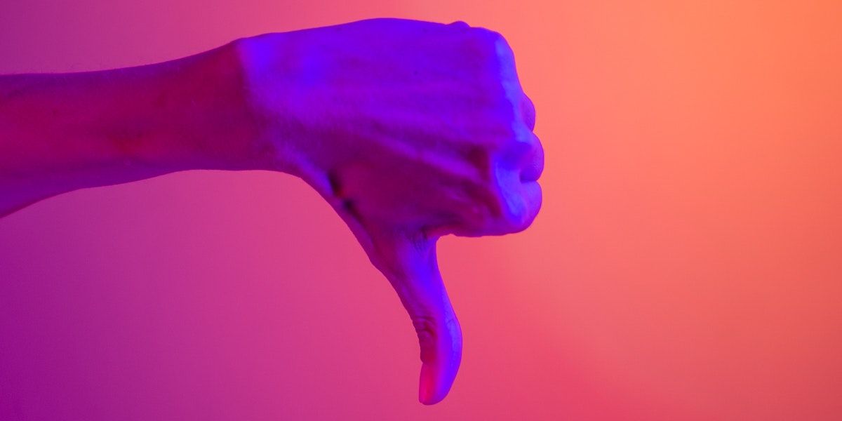 A thumbs down with an orange and purple background