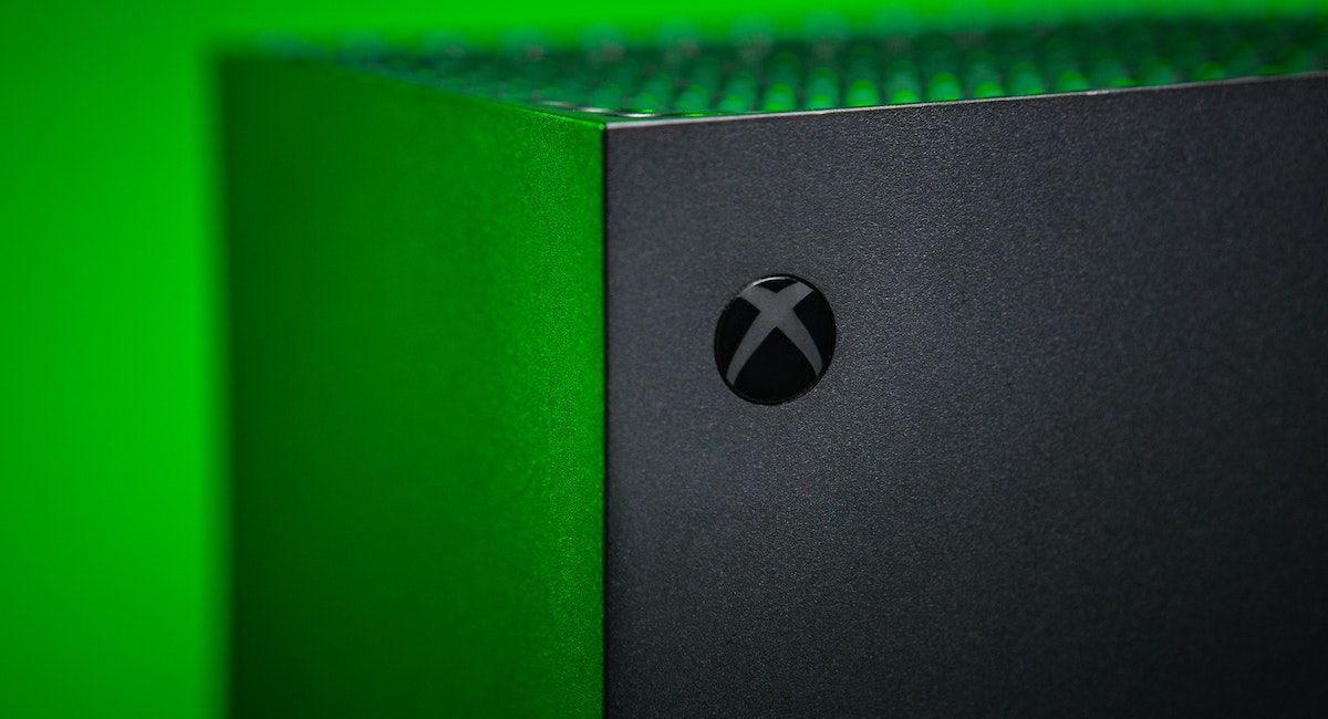 The Xbox logo on an Xbox with a green background