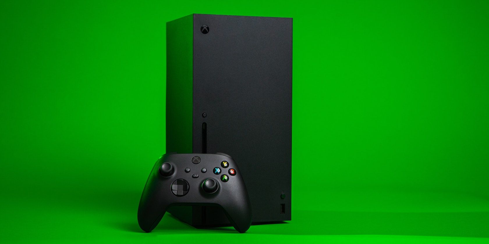 An Xbox Series X and controller with a green background