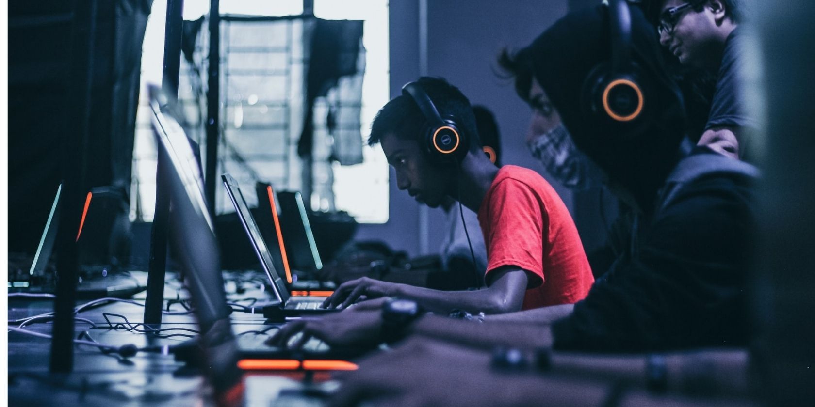 cybersecurity gamers on laptops in headphones