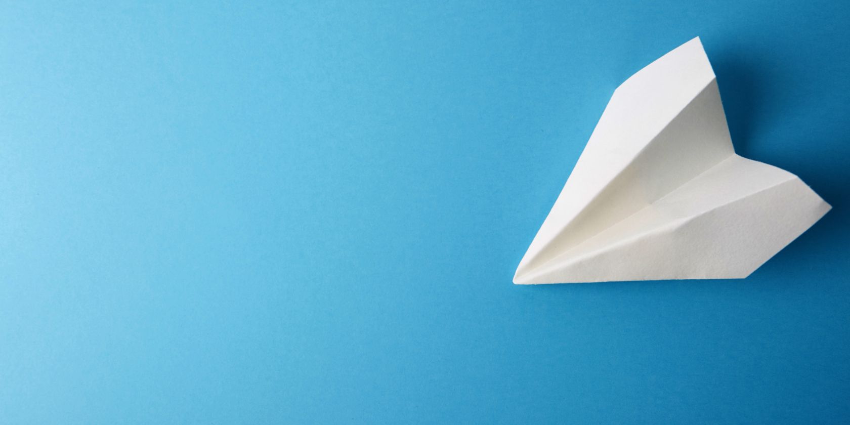 Paper airplane on blue background