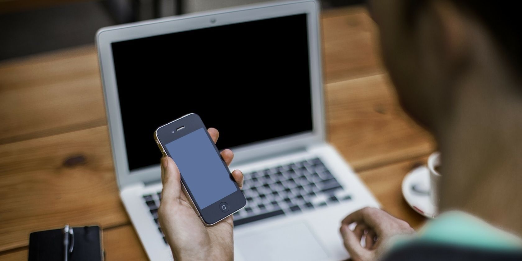 Person looking at blank iPhone and MacBook screen