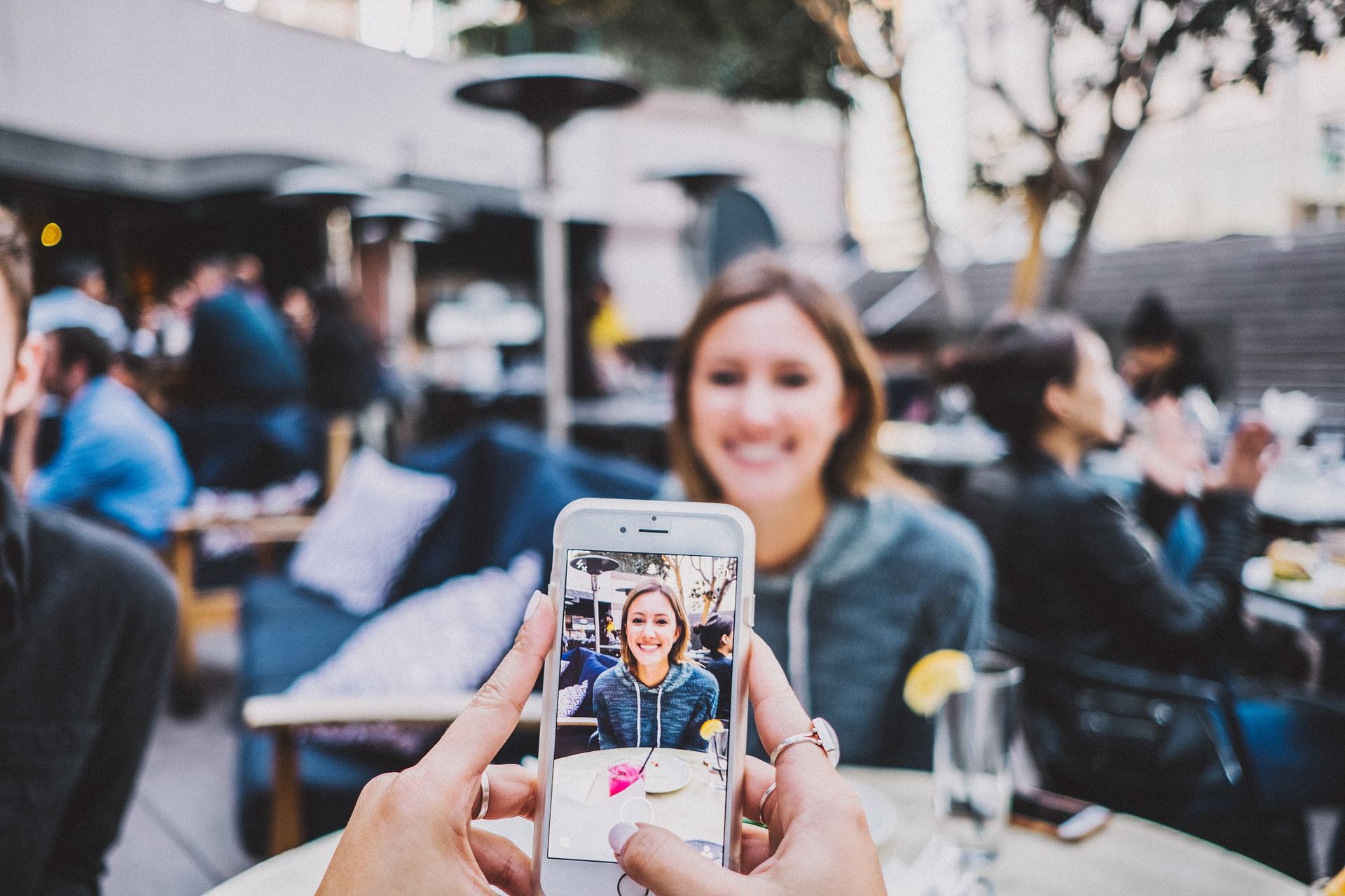 photo of someone taking pictures with their smartphone