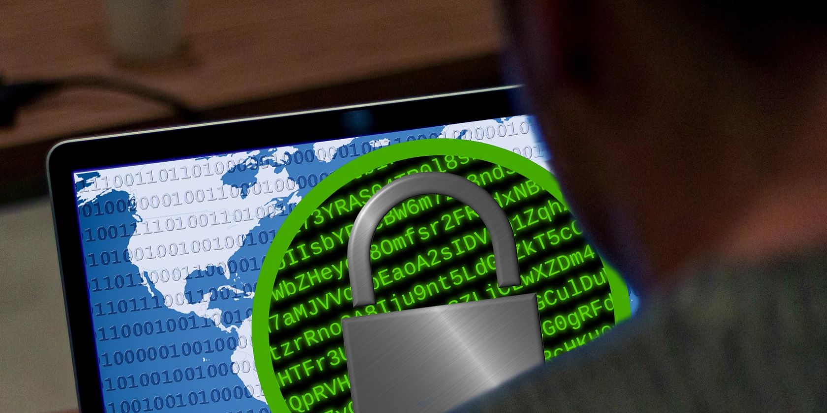 Stock photo shows a man looking at a computer screen with the lock symbol, illustrating a ransomware attack.