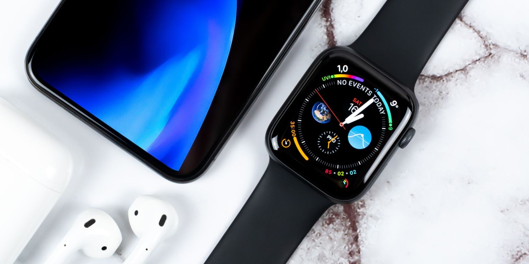 Apple Watch next to an iPhone and AirPods