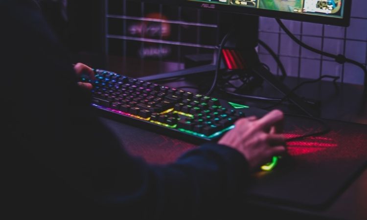 gaming on a lit up keyboard and PC