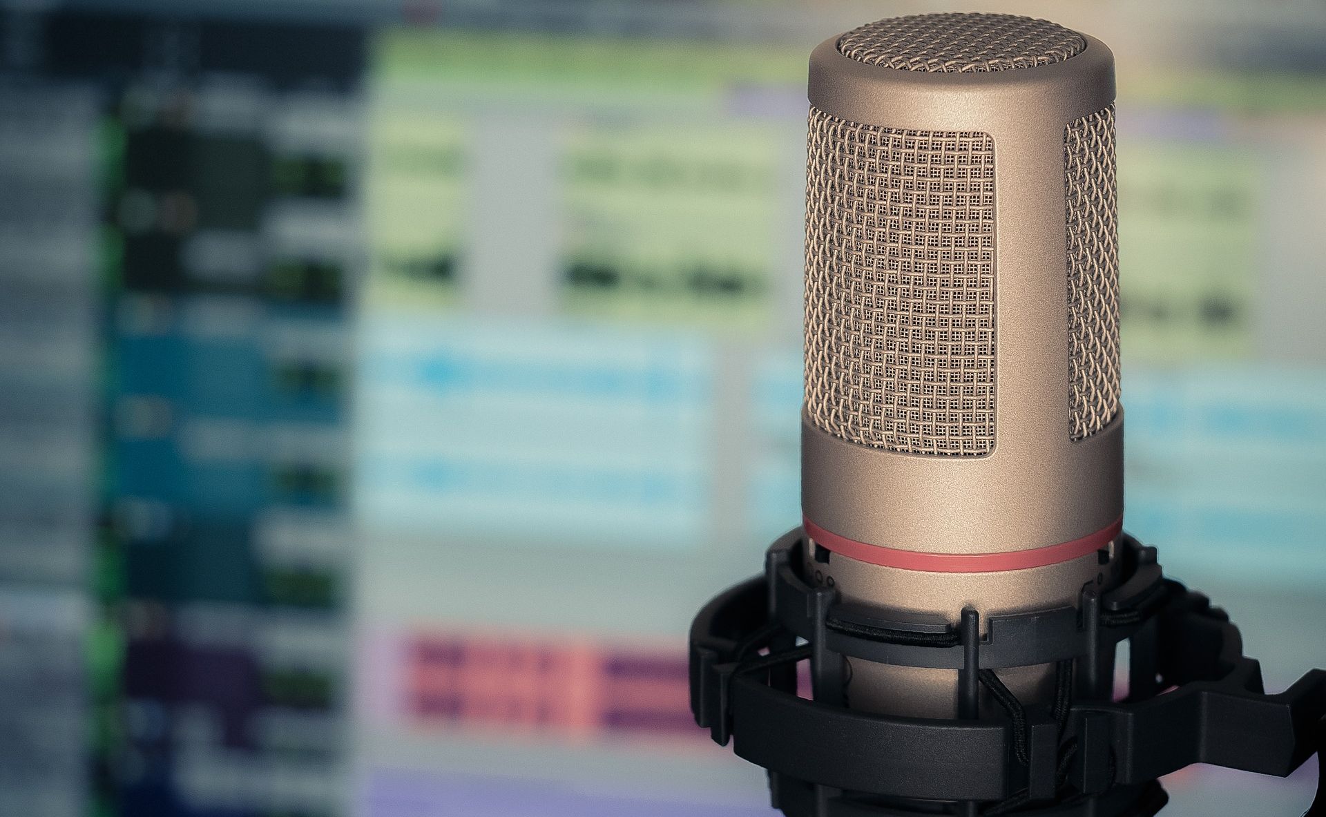 tan microphone in front of blurred computer screen