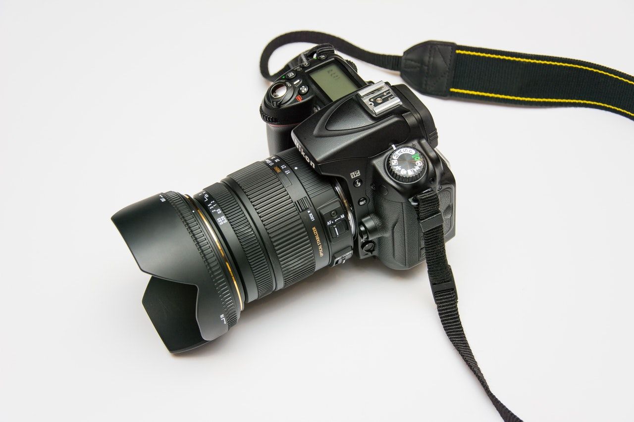 A Nikon camera with a strap