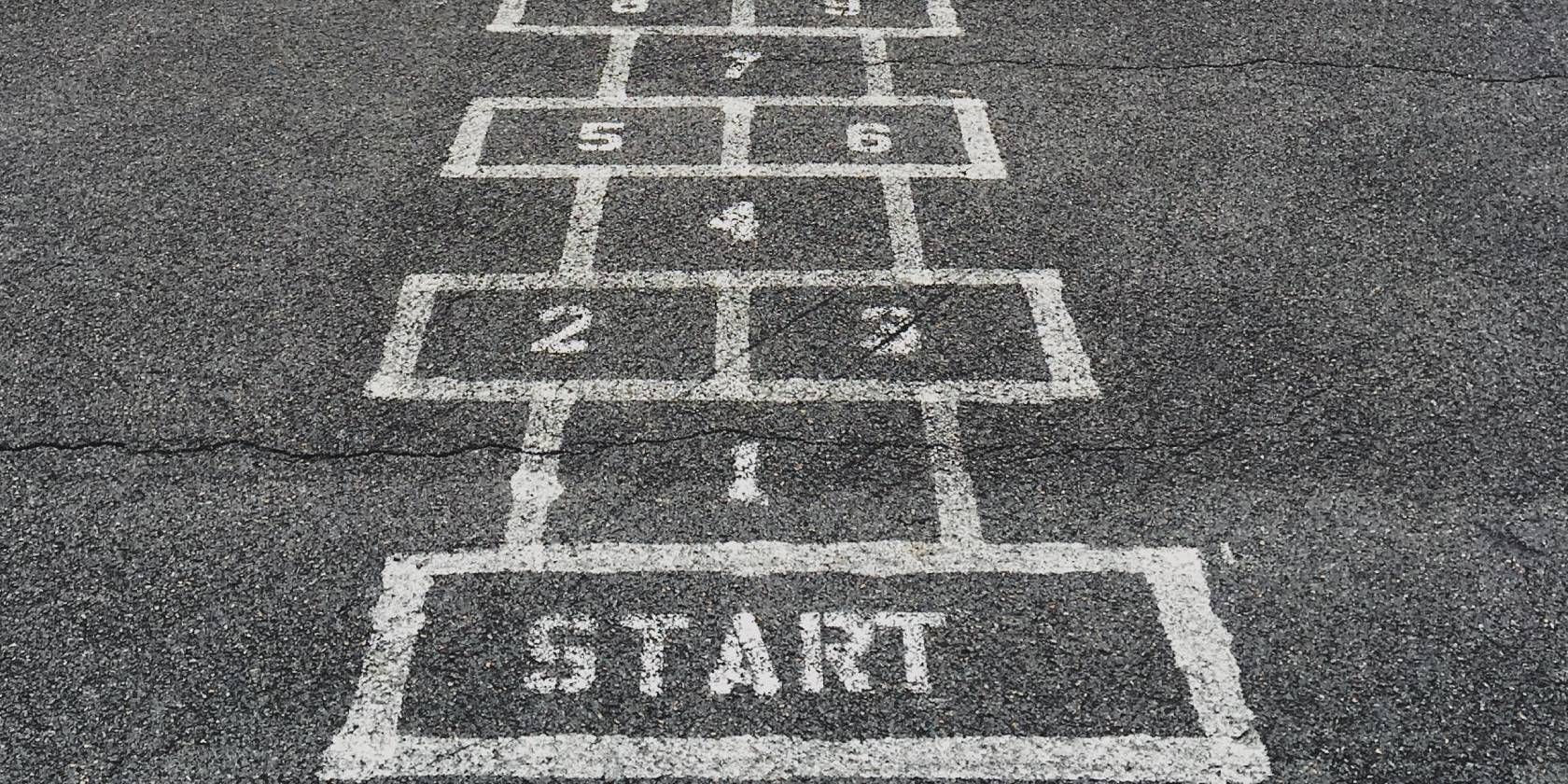 Photo showing a hopscotch painting on a road 